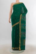 Pure Silk Green Uppada Saree with Zari Butta on the body and Zari Border.  displayed on a mannequin