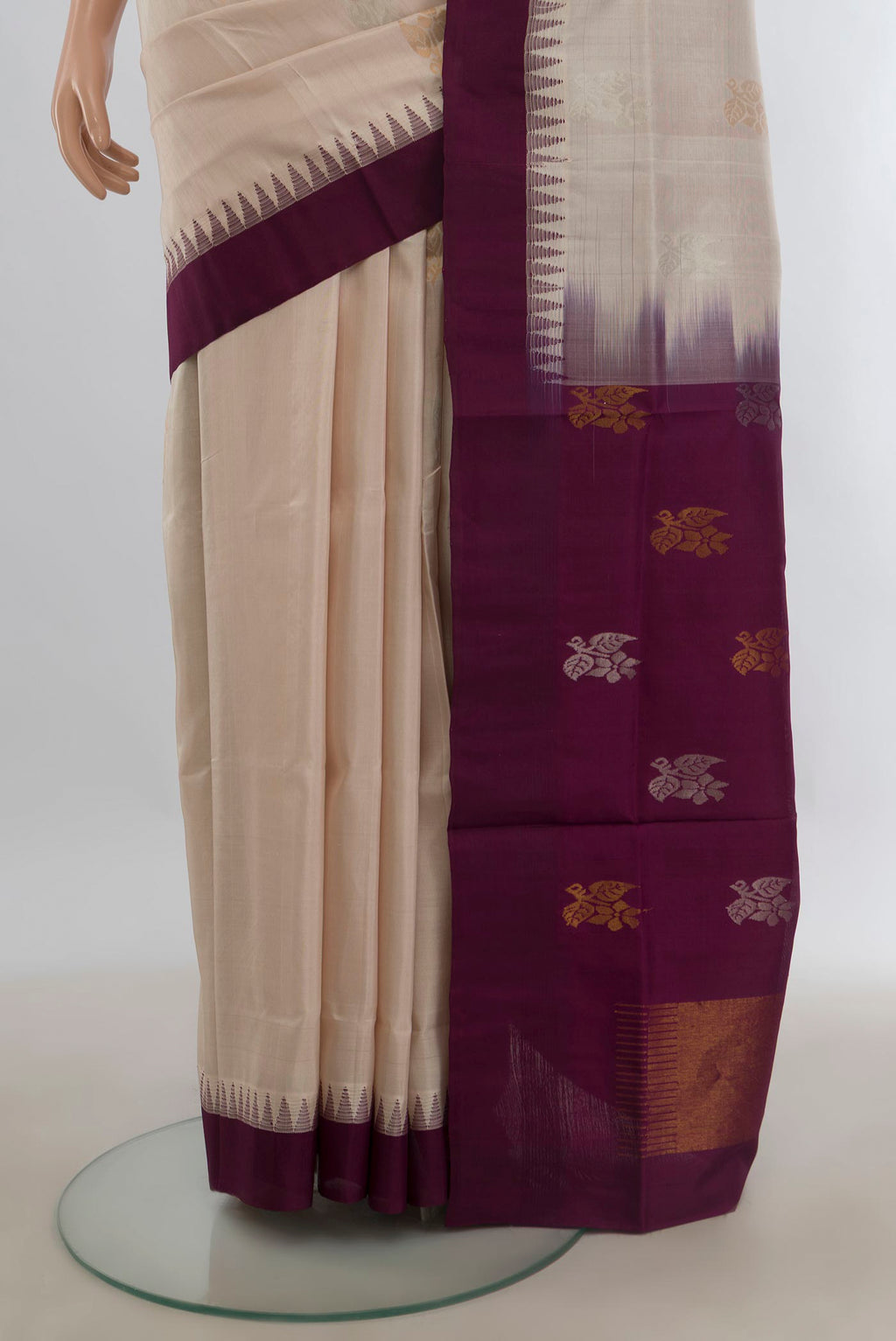 Pleats and pallu of Pure Silk Cream Uppada Saree with Zari Butta on the body and Temple Border. 