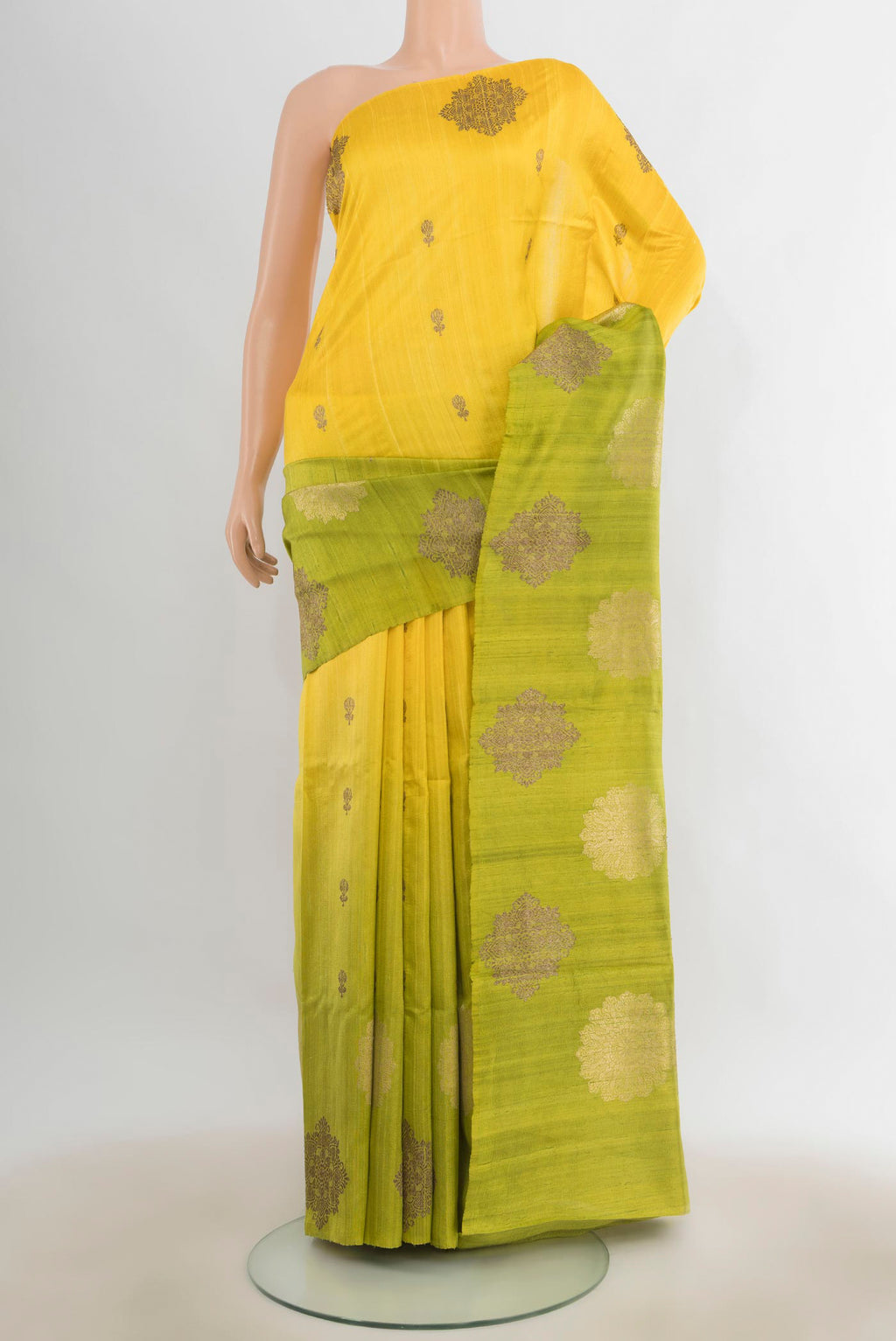 Lemon Yellow Tussar Saree with Zari Butta on the body and Zari Border.  displayed on a mannequin