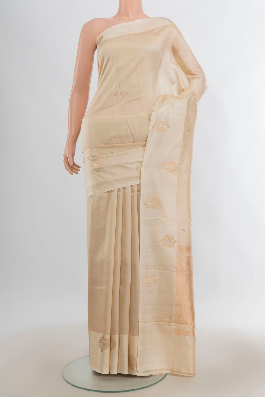 Pure Silk Cream Banarasi Katan Saree with Zari Butta on the body and Plain Border.  displayed on a mannequin