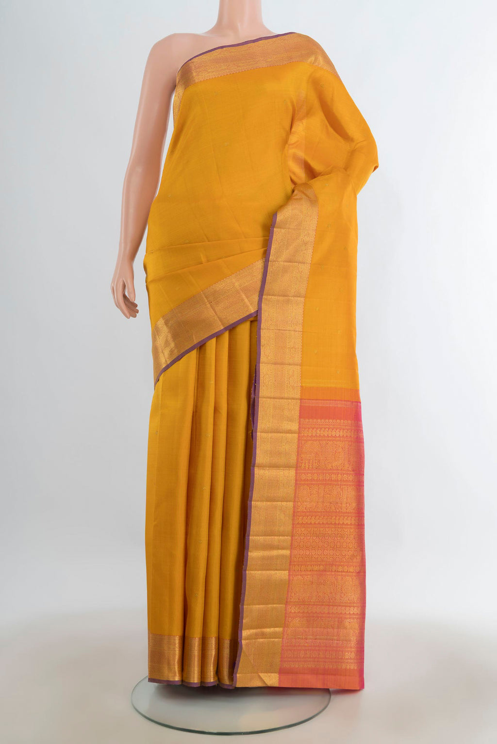 Pure Silk Pure Zari Mustard Kanjivaram Saree with Zari Butta on the body and Silk Border.  displayed on a mannequin