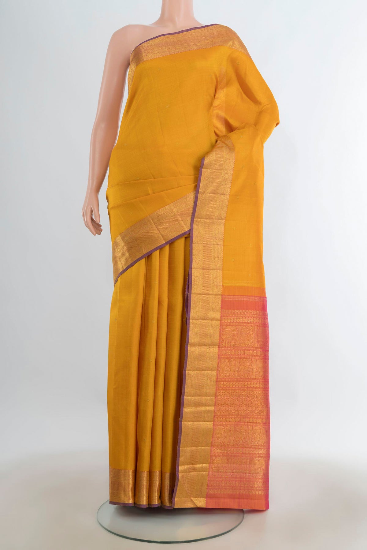 Pure Silk Pure Zari Mustard Kanjivaram Saree with Zari Butta on the body and Silk Border.  displayed on a mannequin