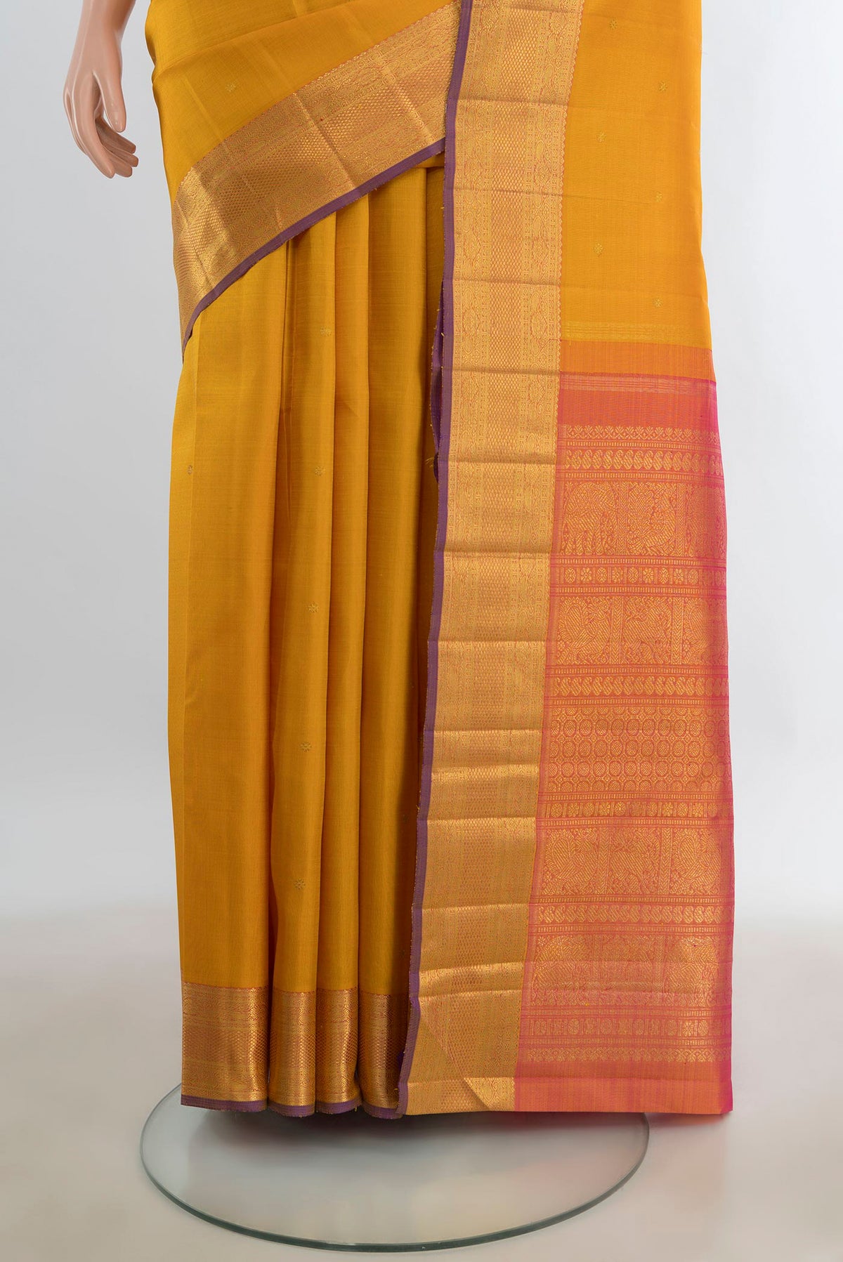 Pleats and pallu of Pure Silk Pure Zari Mustard Kanjivaram Saree with Zari Butta on the body and Silk Border. 