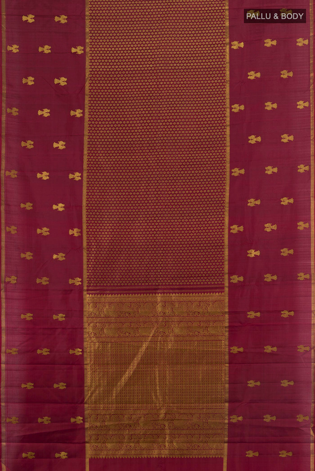 Flat view of Pure Silk Maroon Kanjivaram Saree with Zari Butta on the body and Plain Border. 