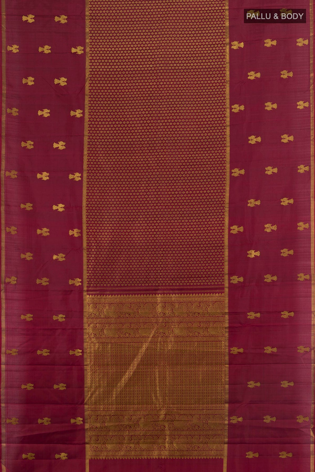 Flat view of Pure Silk Maroon Kanjivaram Saree with Zari Butta on the body and Plain Border. 