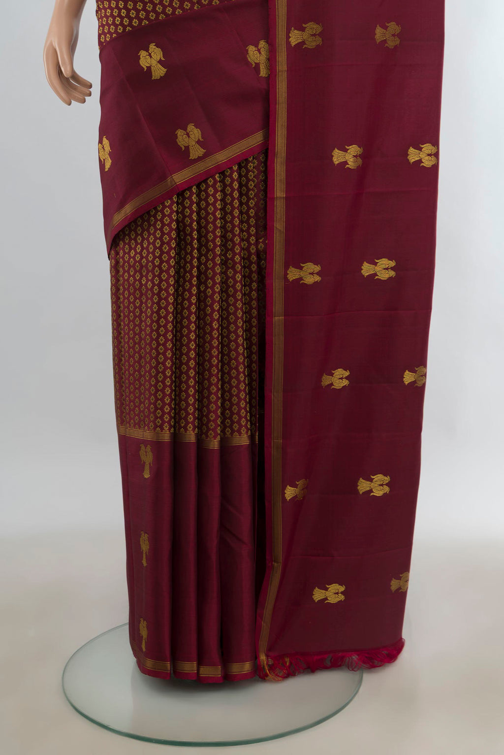 Pleats and pallu of Pure Silk Maroon Kanjivaram Saree with Zari Butta on the body and Plain Border. 