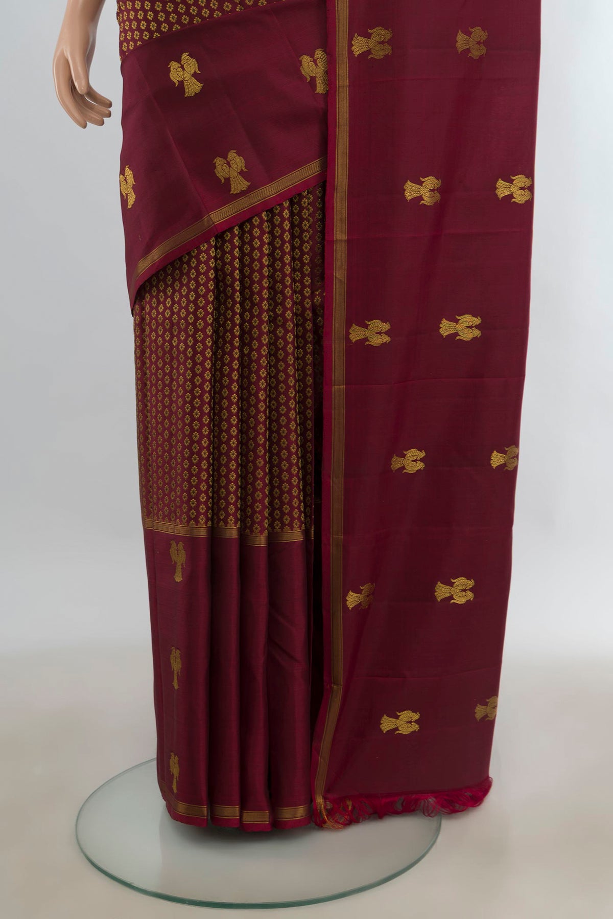Pleats and pallu of Pure Silk Maroon Kanjivaram Saree with Zari Butta on the body and Plain Border. 