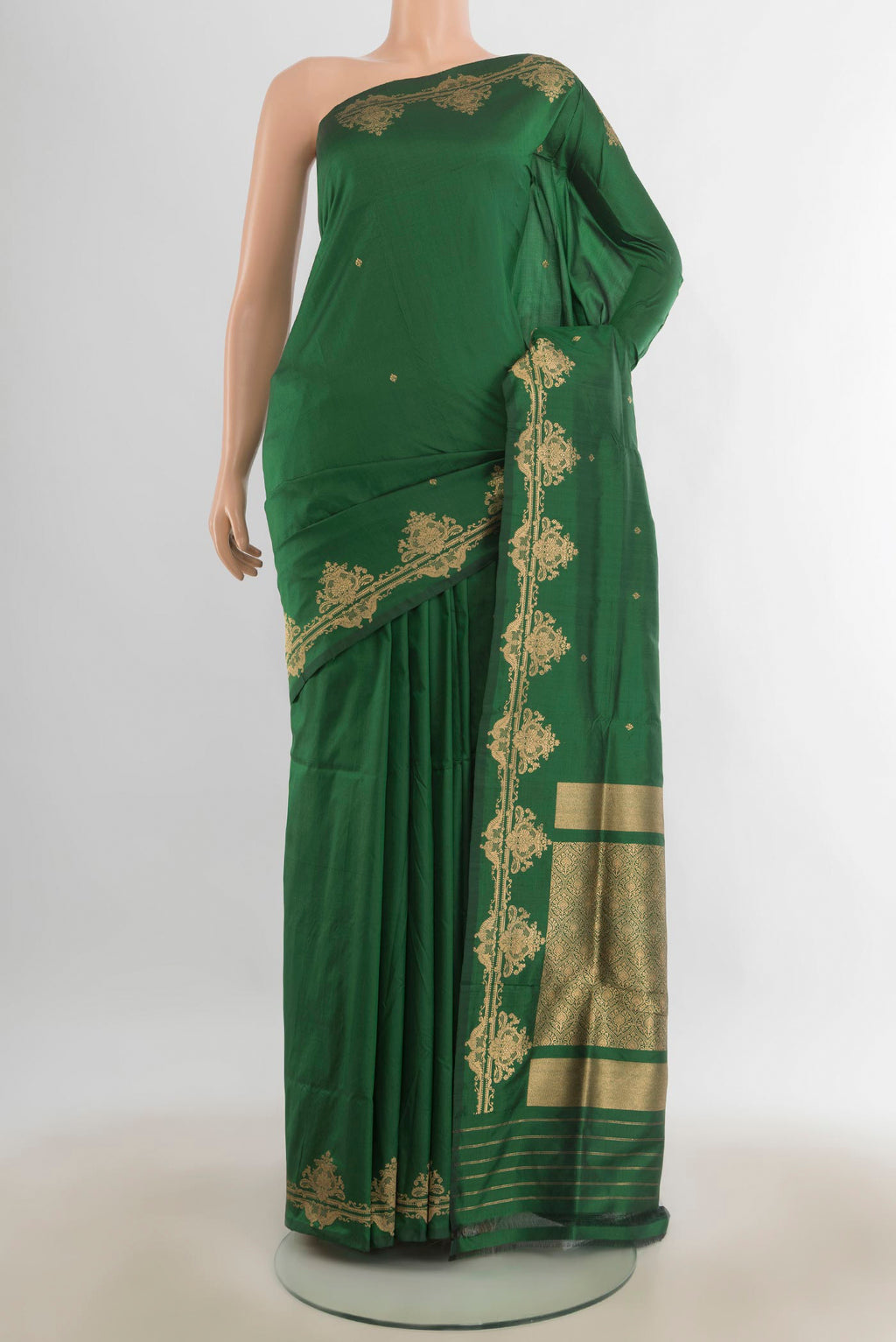 Pure Silk Bottle Green Banarasi Katan Saree with Zari Butta on the body and Silk Border.  displayed on a mannequin