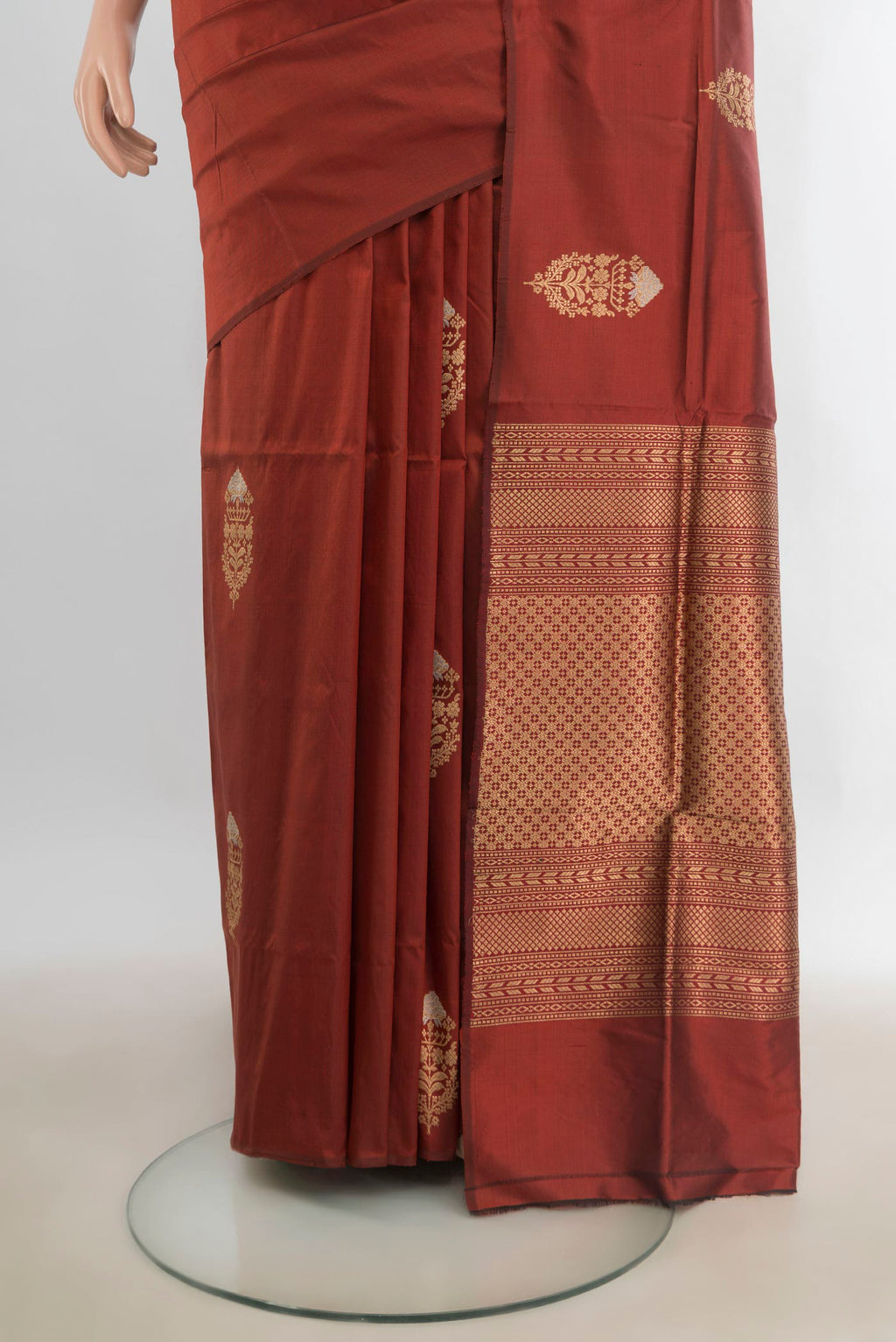 Pleats and pallu of Pure Silk Rust Banarasi Katan Saree with Zari Butta on the body and Without Border. 