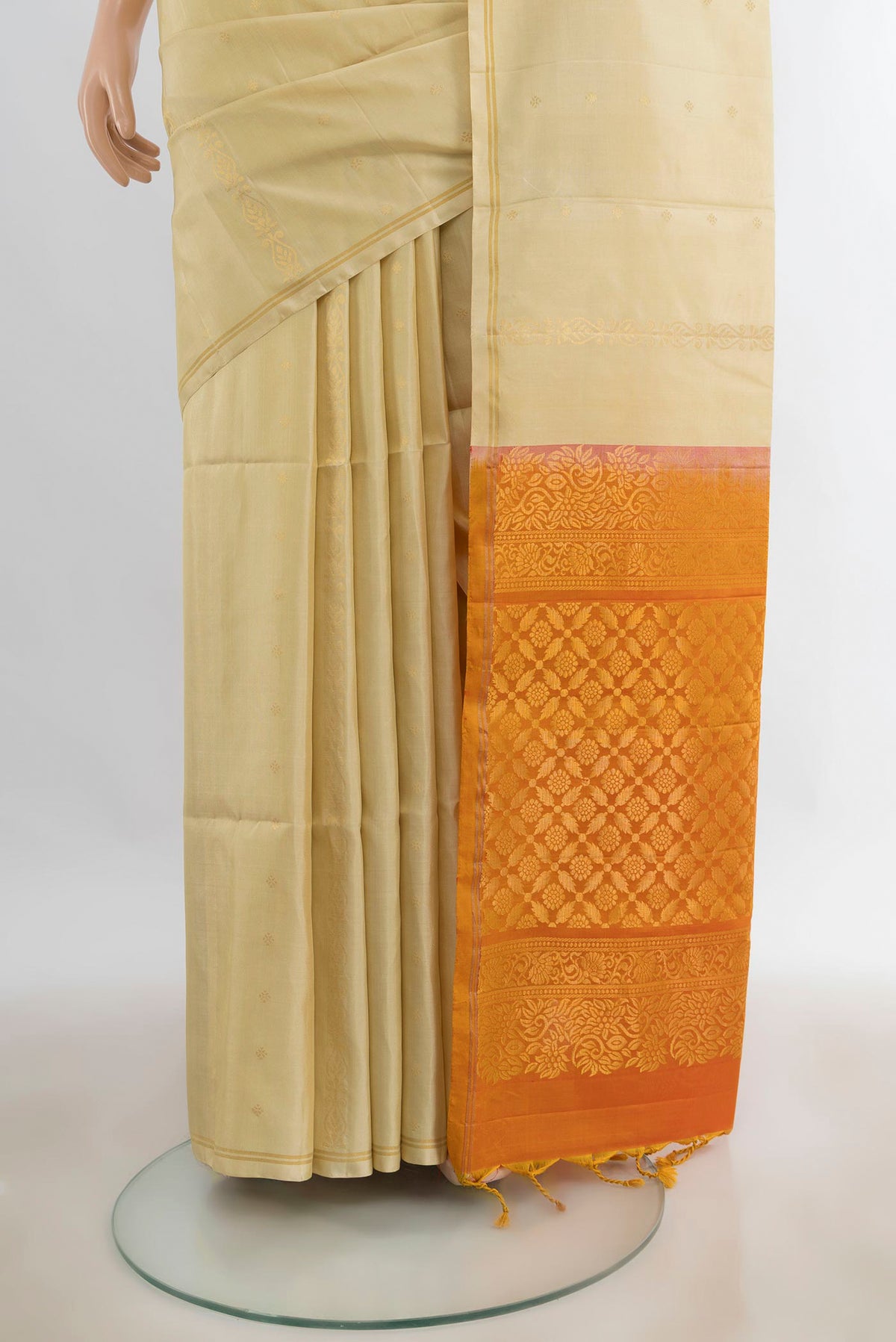 Pleats and pallu of Pure Silk Cream Soft Saree with Zari Butta on the body and Thin Zari Line. 