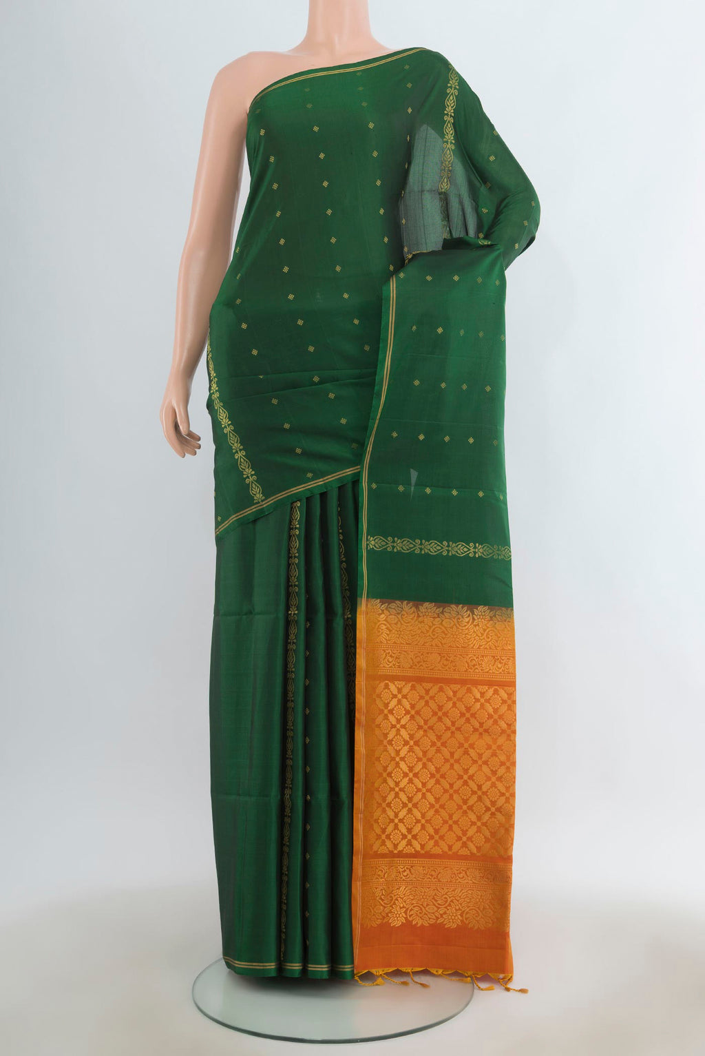 Pure Silk Bottle Green Soft Saree with Zari Butta on the body and Zari Border.  displayed on a mannequin