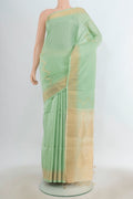 Pure Silk Pista Green Soft Saree with Zari Butta on the body and Silk Border.  displayed on a mannequin