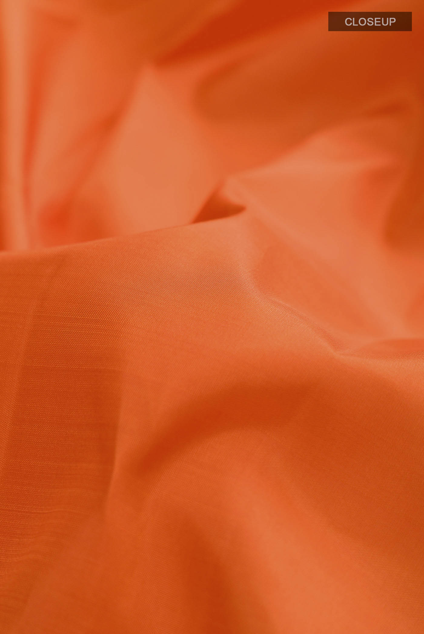 Close up of Orange Kanchipuram Silk Nine Yards Saree with Plain Body and Zari Border displaying folds