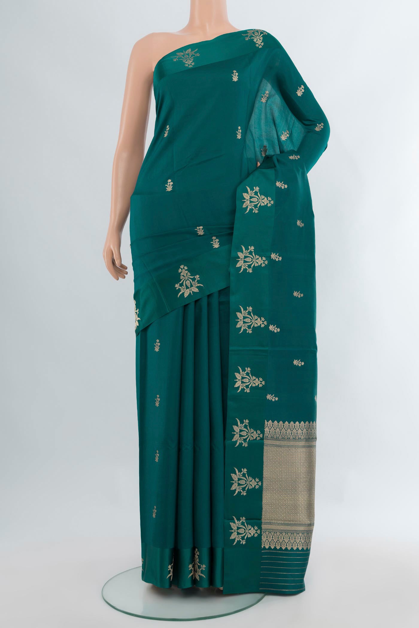 Peacock Blue Banarasi Katan Silk Saree with Zari Butta on the body and Satin Border.  displayed on a mannequin