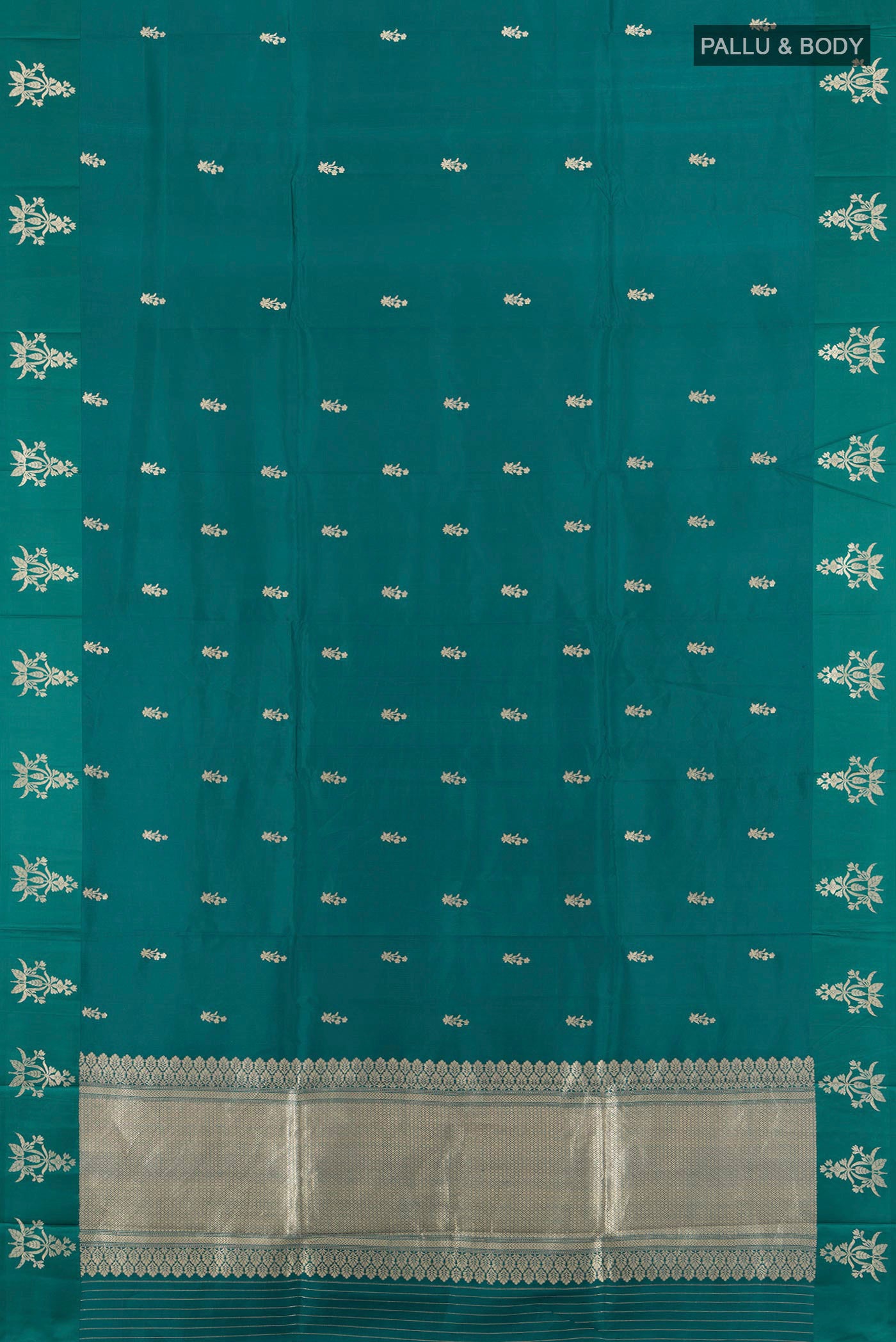 Flat view of Peacock Blue Banarasi Katan Silk Saree with Zari Butta on the body and Satin Border. 