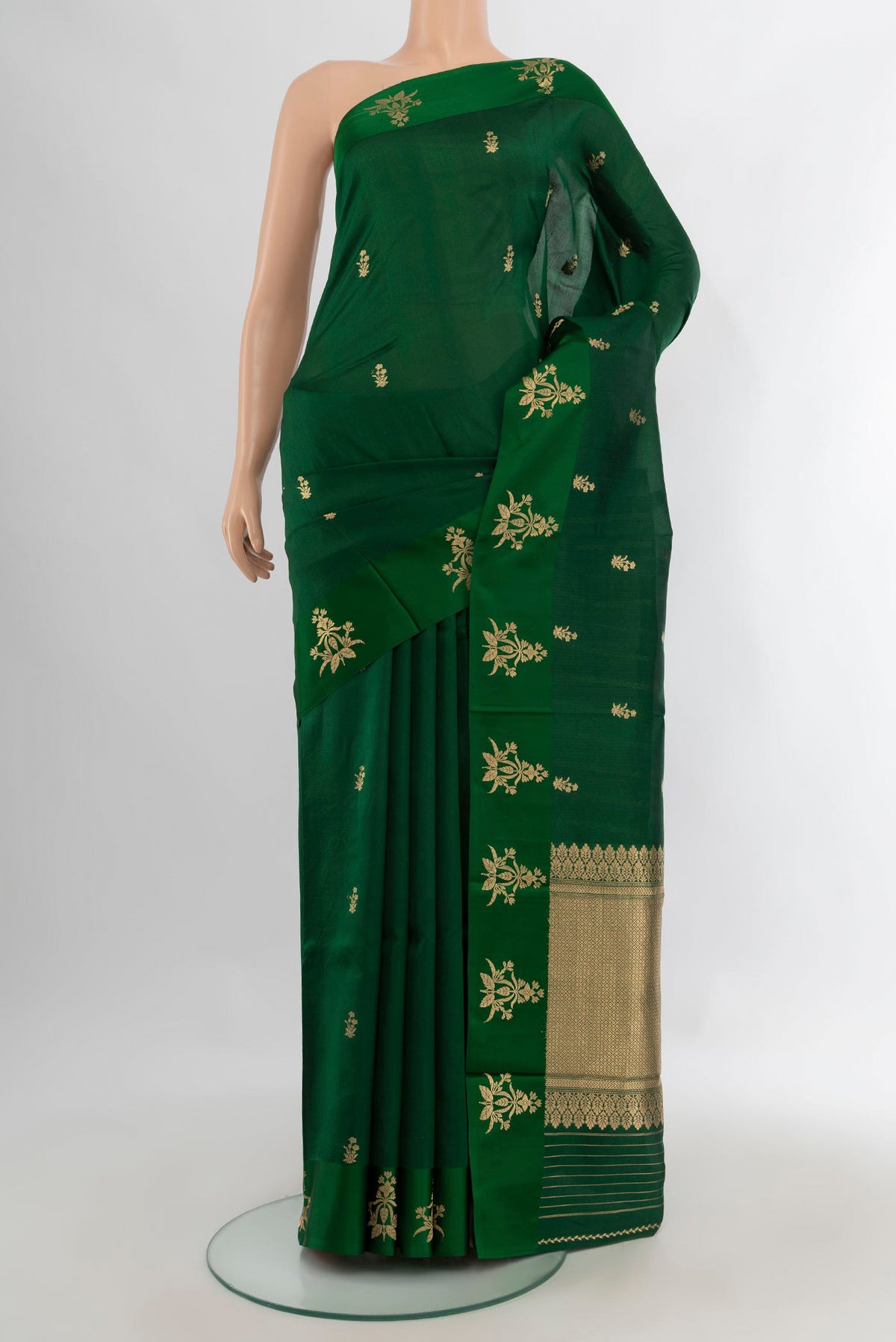Pure Silk Bottle Green Banarasi Katan Saree with Zari Butta on the body and Plain Border.  displayed on a mannequin