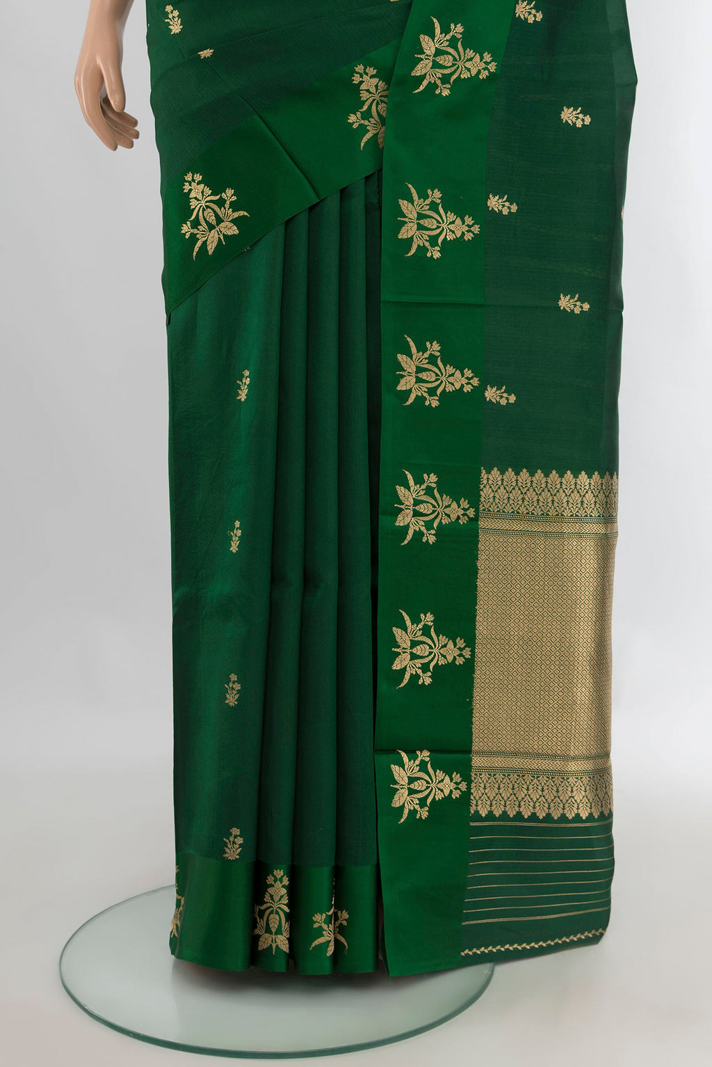 Pleats and pallu of Pure Silk Bottle Green Banarasi Katan Saree with Zari Butta on the body and Plain Border. 