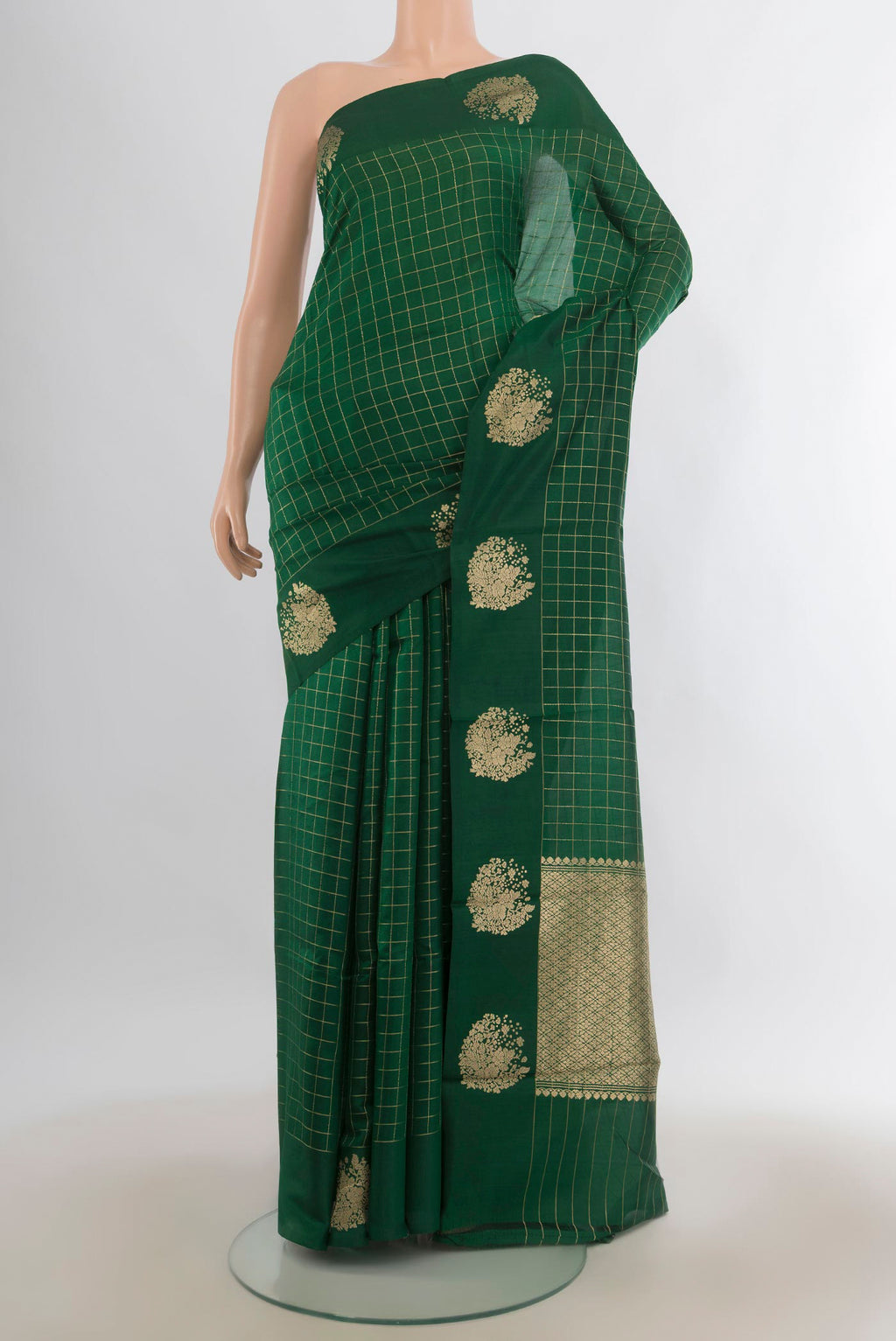 Pure Silk Bottle Green Banarasi Katan Saree with Checked design on the body and Plain Border.  displayed on a mannequin
