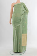 Pure Silk Pista Green Banarasi Katan Saree with Zari Butta on the body and Plain Border.  displayed on a mannequin