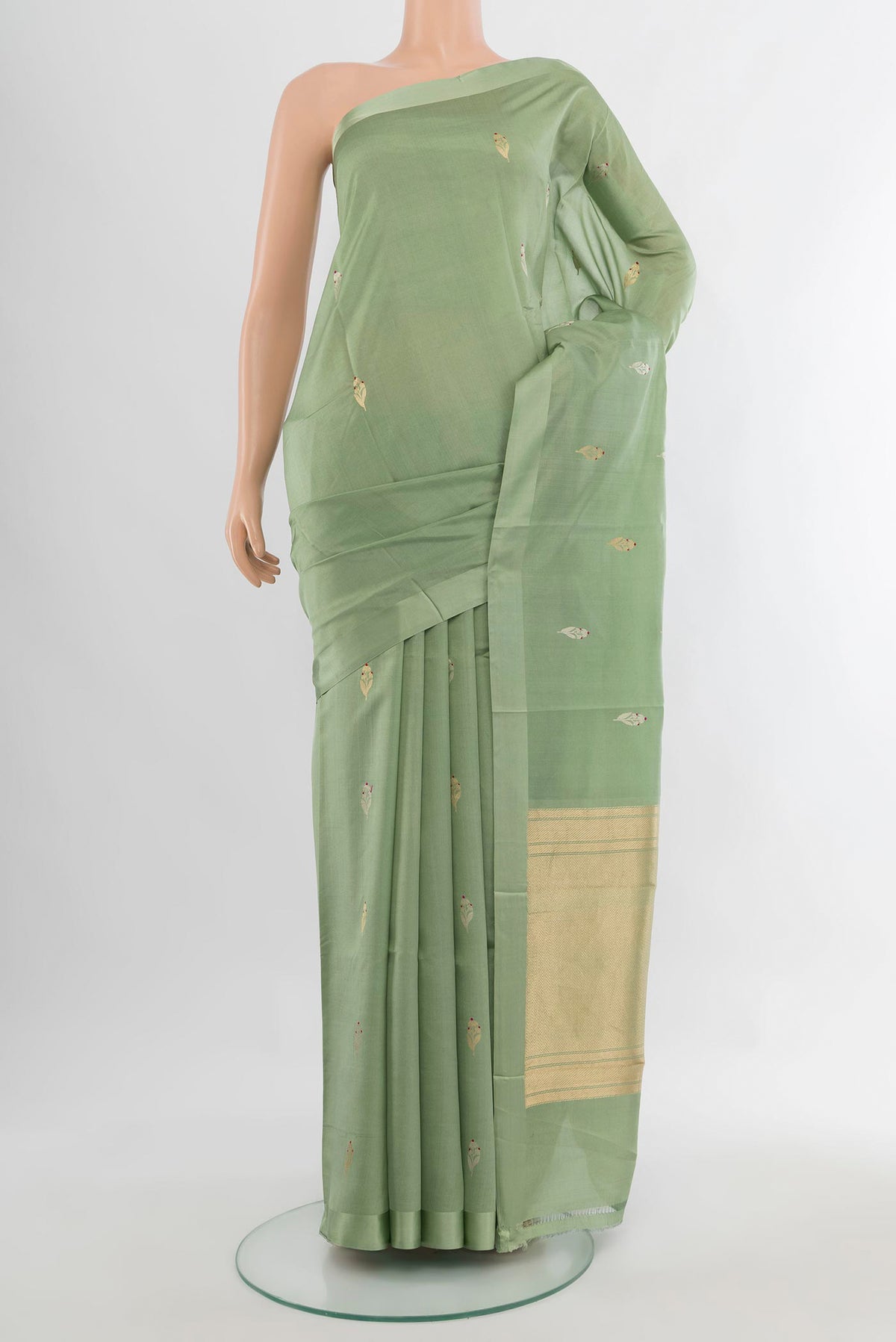 Pure Silk Pista Green Banarasi Katan Saree with Zari Butta on the body and Plain Border.  displayed on a mannequin