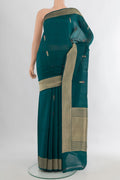 Pure Silk Blue Banarasi Katan Saree with Zari Butta on the body and Zari Border.  displayed on a mannequin