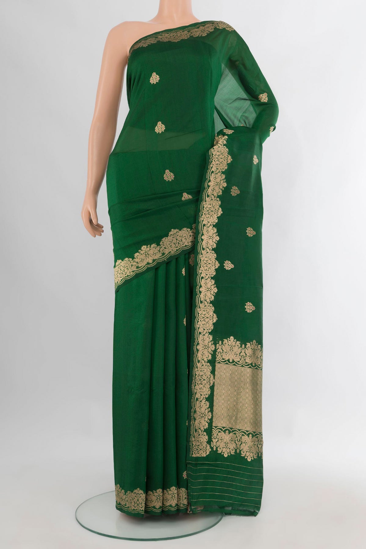 Pure Silk Bottle Green Banarasi Katan Saree with Zari Butta on the body and Fancy Border.  displayed on a mannequin