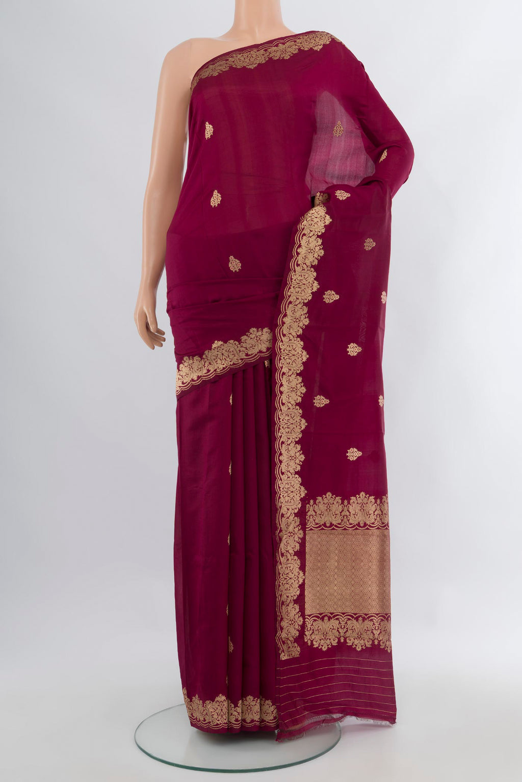 Maroon Banarasi Katan Silk Saree with Zari Butta on the body and Fancy Border.  displayed on a mannequin