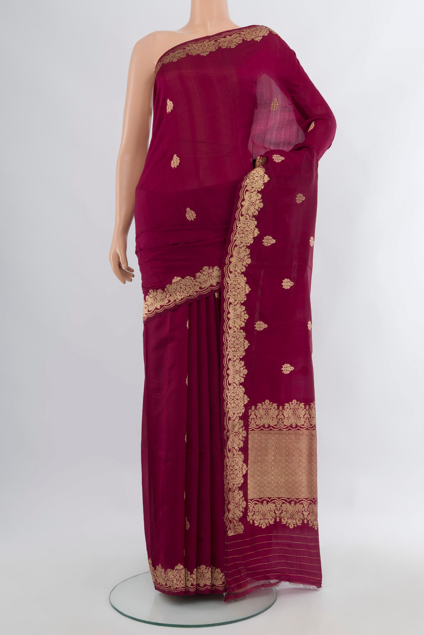 Maroon Banarasi Katan Silk Saree with Zari Butta on the body and Fancy Border.  displayed on a mannequin