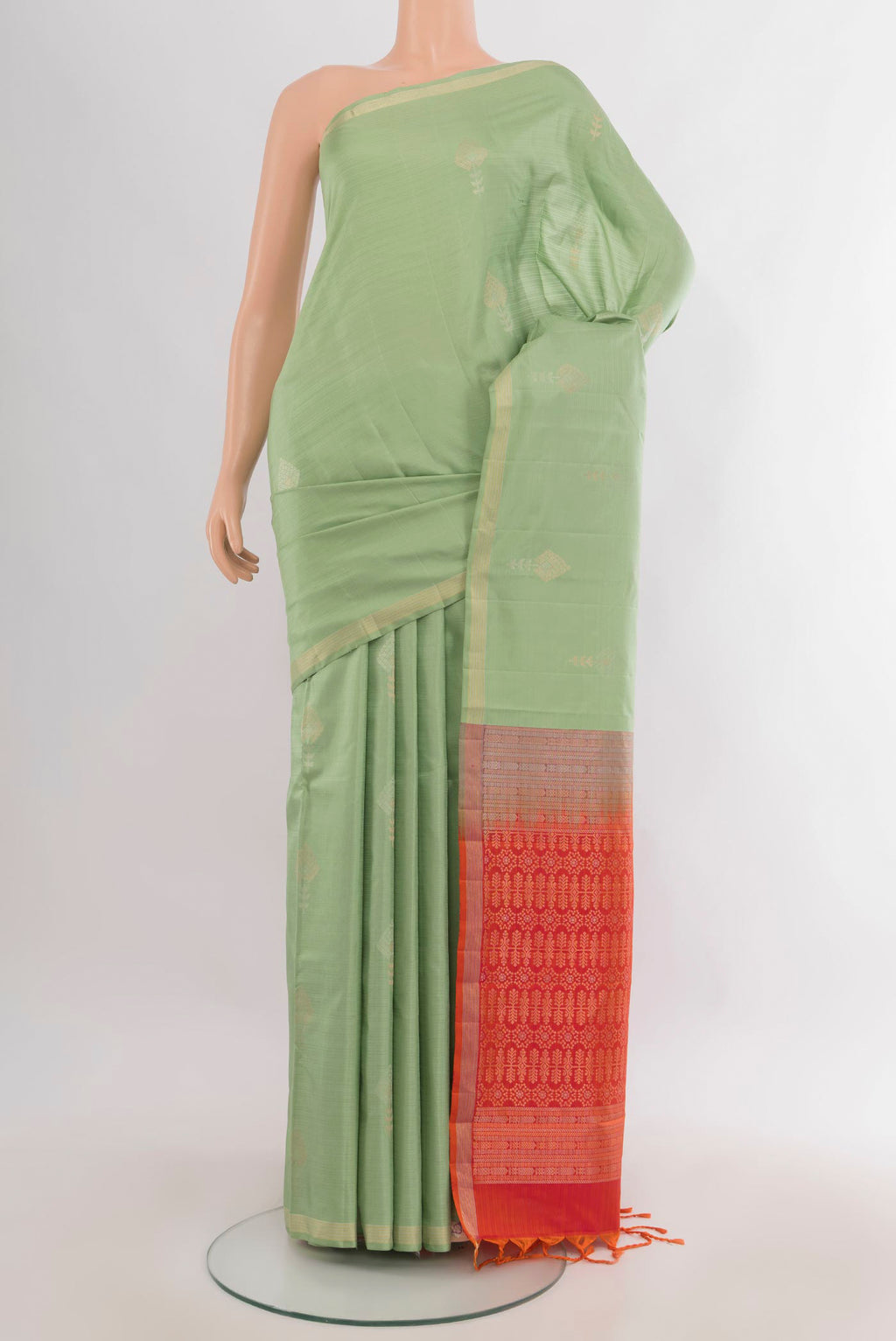 Pure Silk Pista Green Soft Saree with Zari Butta on the body and Zari Border.  displayed on a mannequin