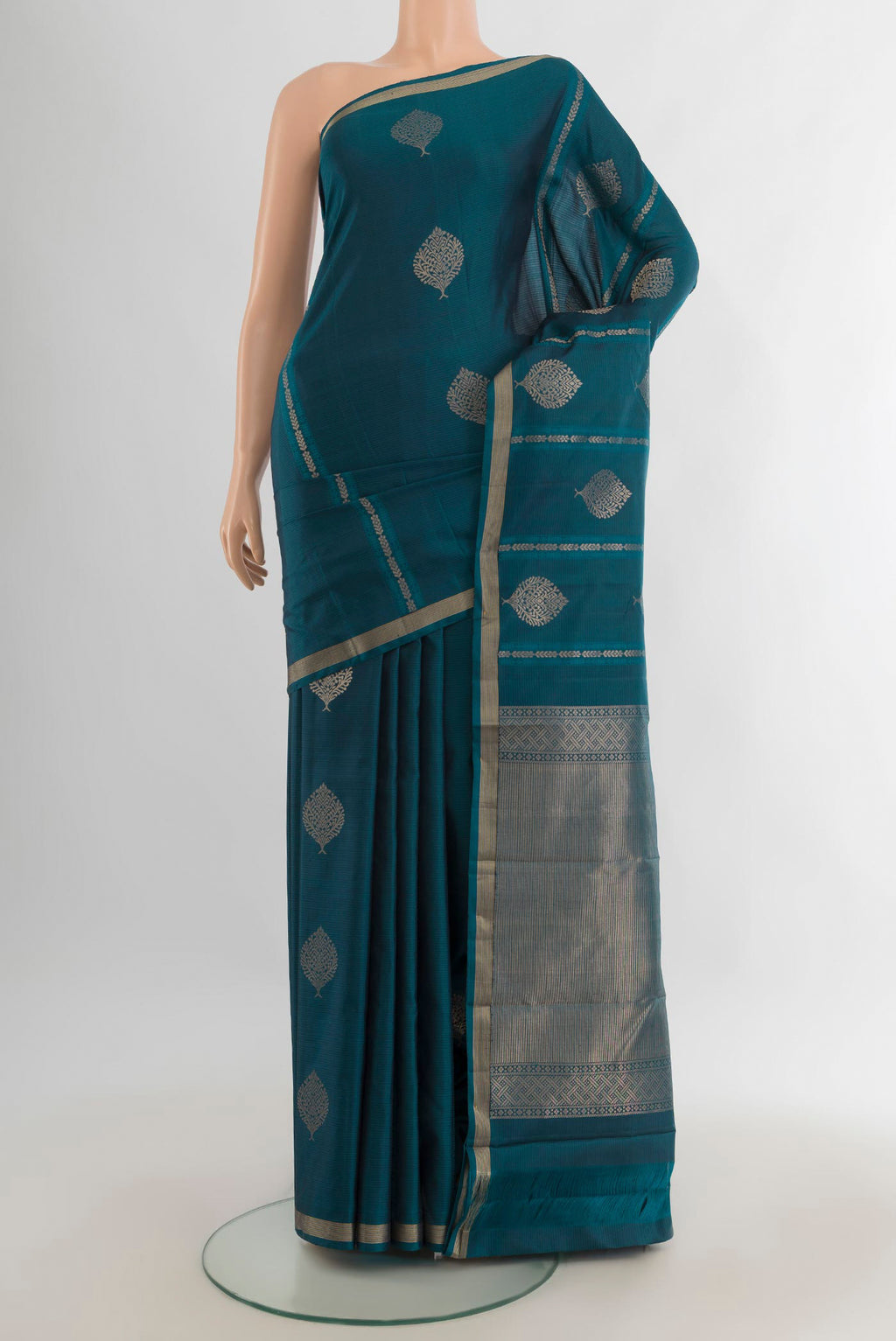 Pure Silk Peacock Blue Soft Saree with Zari Butta on the body and Zari Border.  displayed on a mannequin
