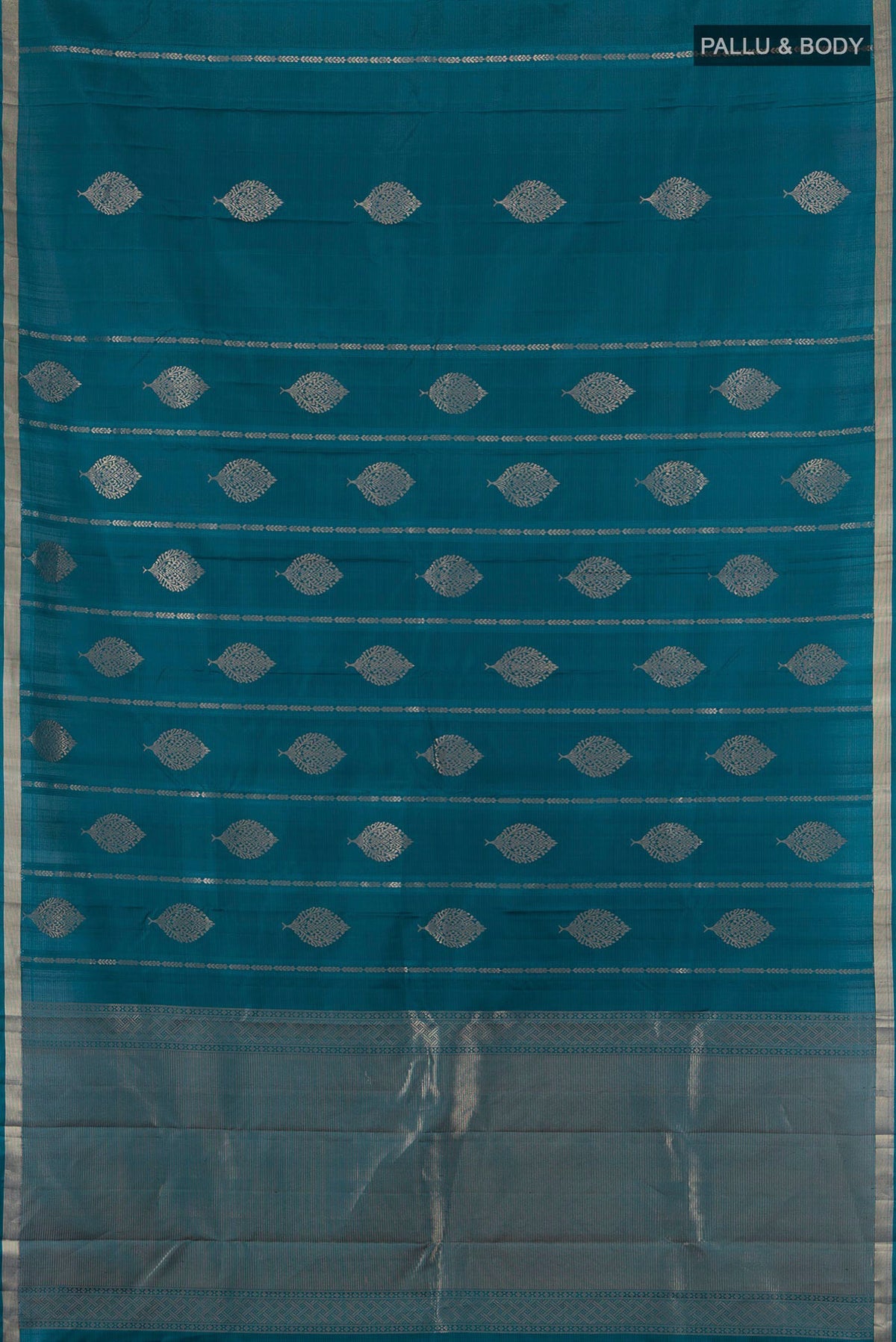 Flat view of Pure Silk Peacock Blue Soft Saree with Zari Butta on the body and Zari Border. 