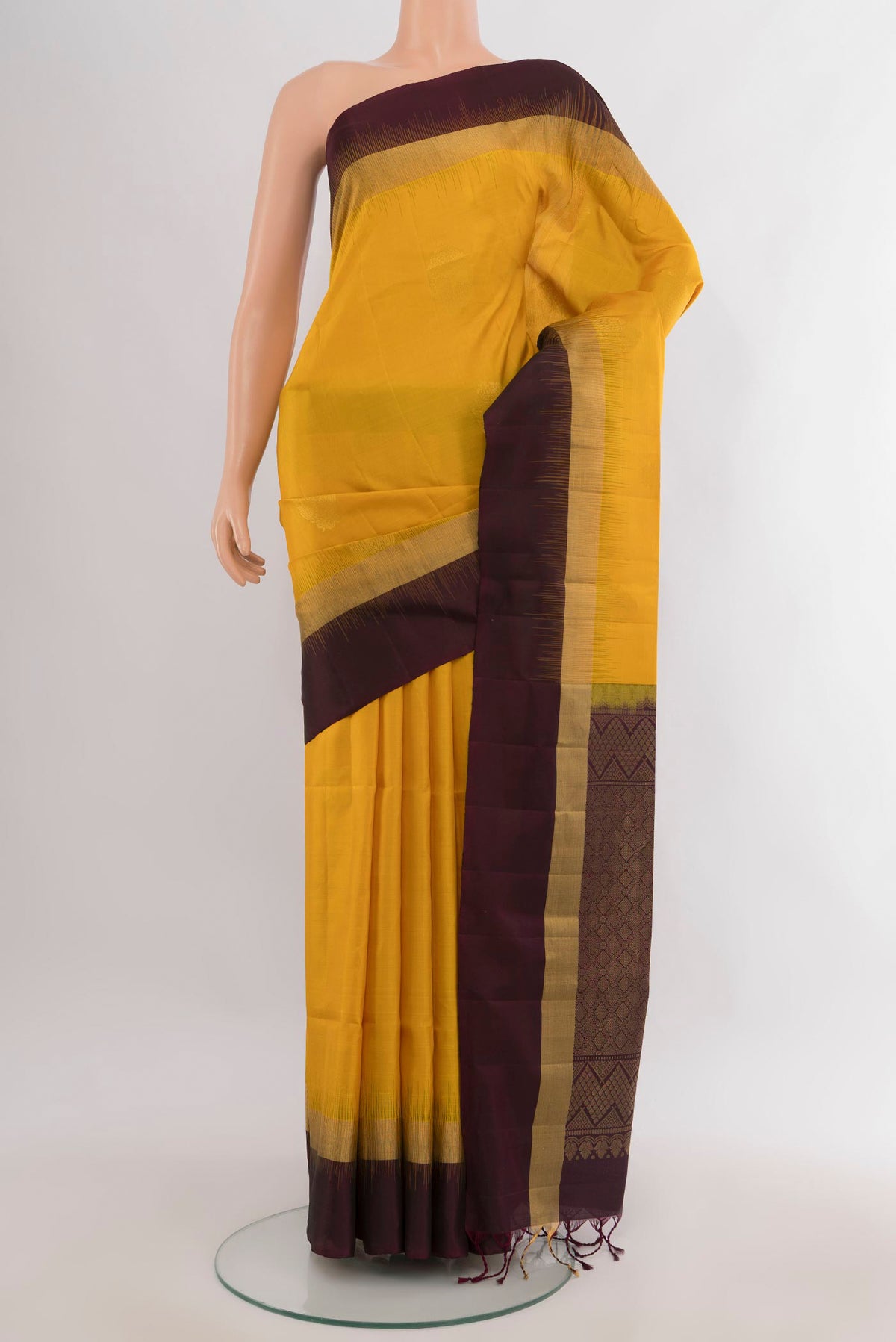 Pure Silk Mustard Soft Saree with Zari Butta on the body and Plain Border.  displayed on a mannequin