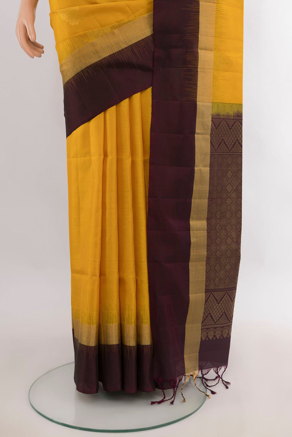 Pleats and pallu of Pure Silk Mustard Soft Saree with Zari Butta on the body and Plain Border. 
