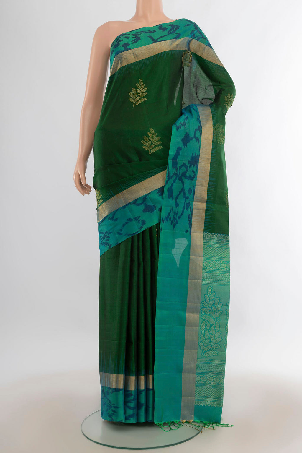 Pure Silk Green Soft Saree with Zari Butta on the body and Ikat Border.  displayed on a mannequin