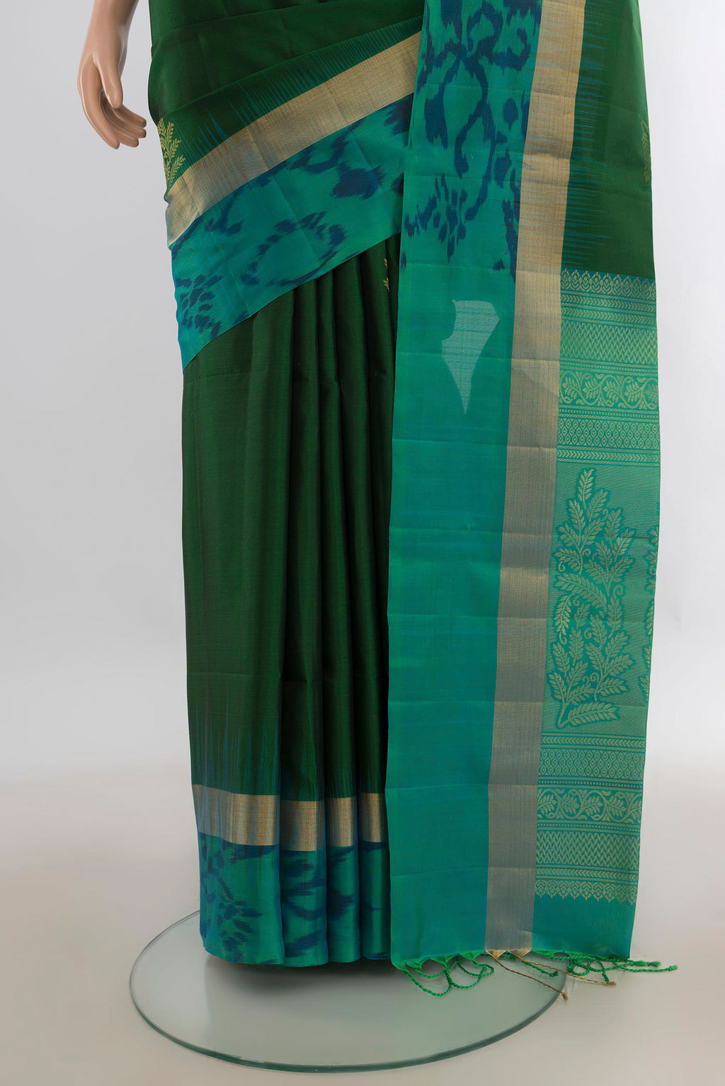 Pleats and pallu of Pure Silk Green Soft Saree with Zari Butta on the body and Ikat Border. 