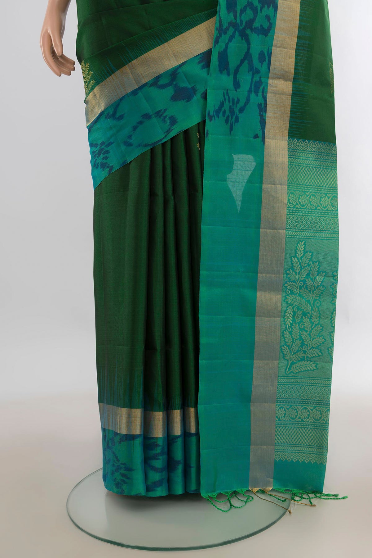Pleats and pallu of Pure Silk Green Soft Saree with Zari Butta on the body and Ikat Border. 
