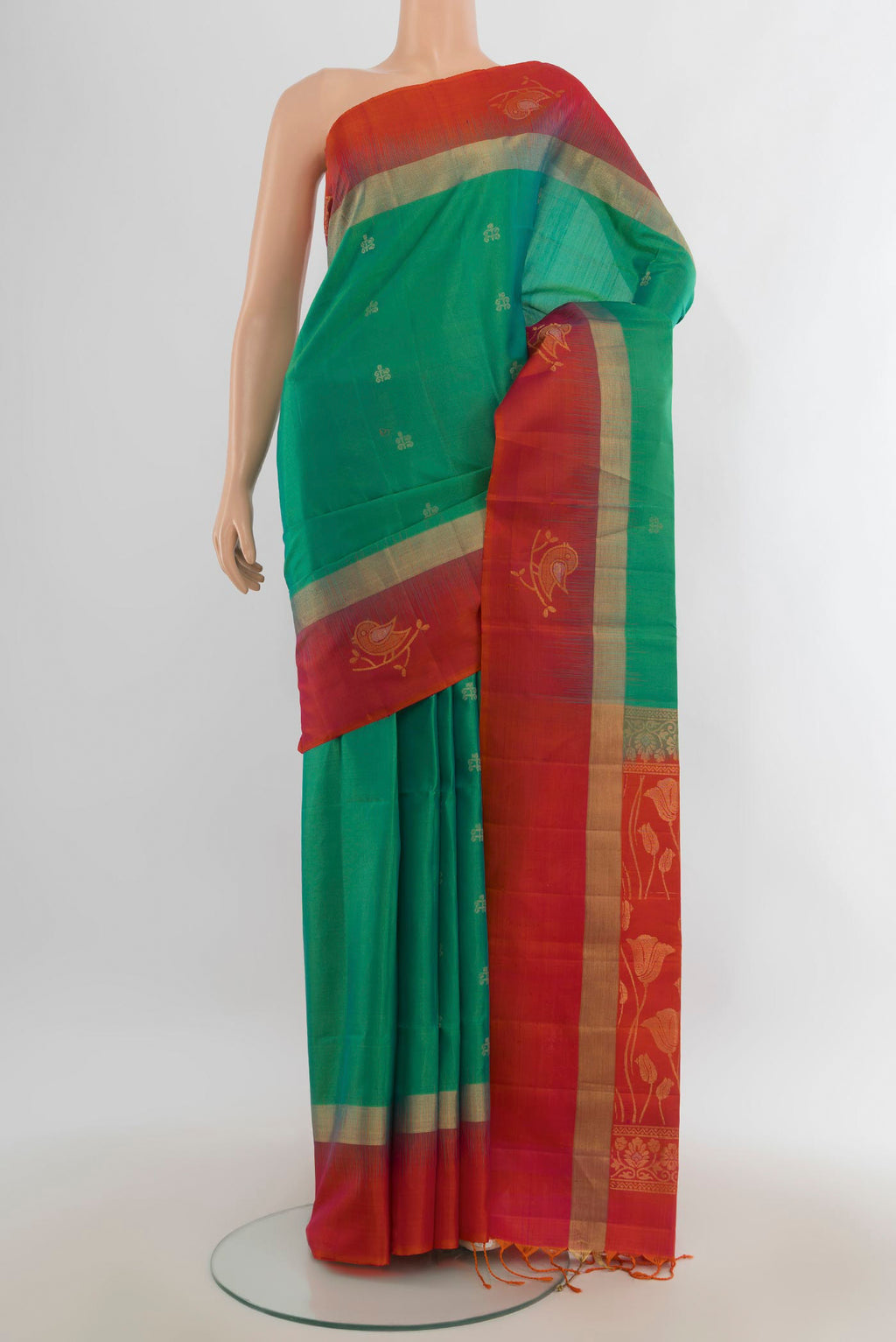 Pure Silk Light Green Soft Saree with Zari Butta on the body and Silk Border.  displayed on a mannequin