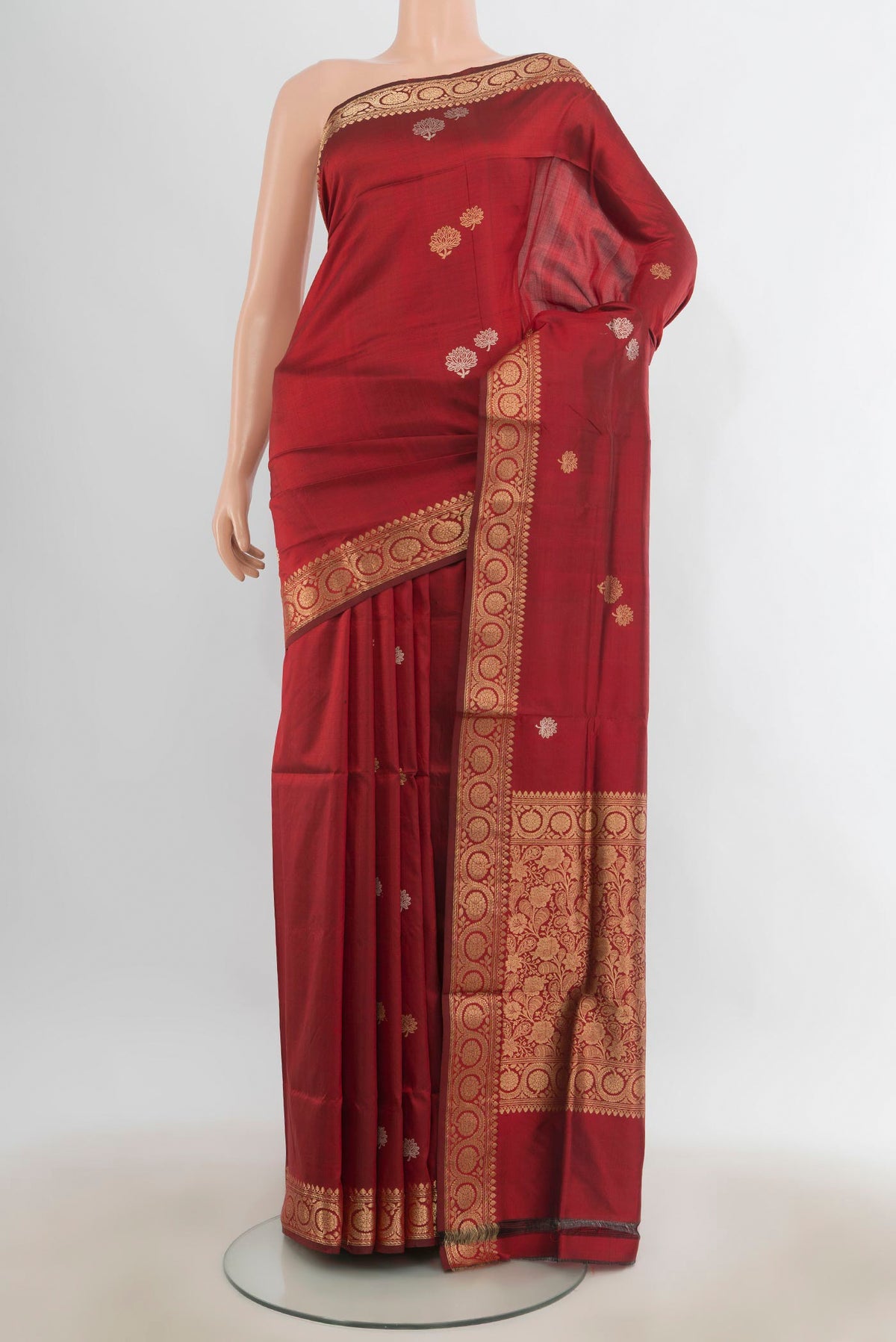 Pure Silk Maroon Banarasi Katan Saree with Zari Butta on the body and Zari Border.  displayed on a mannequin