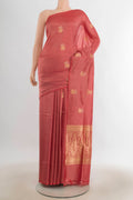 Pure Silk Peach Banarasi Katan Saree with Zari Butta on the body and Silk Border.  displayed on a mannequin