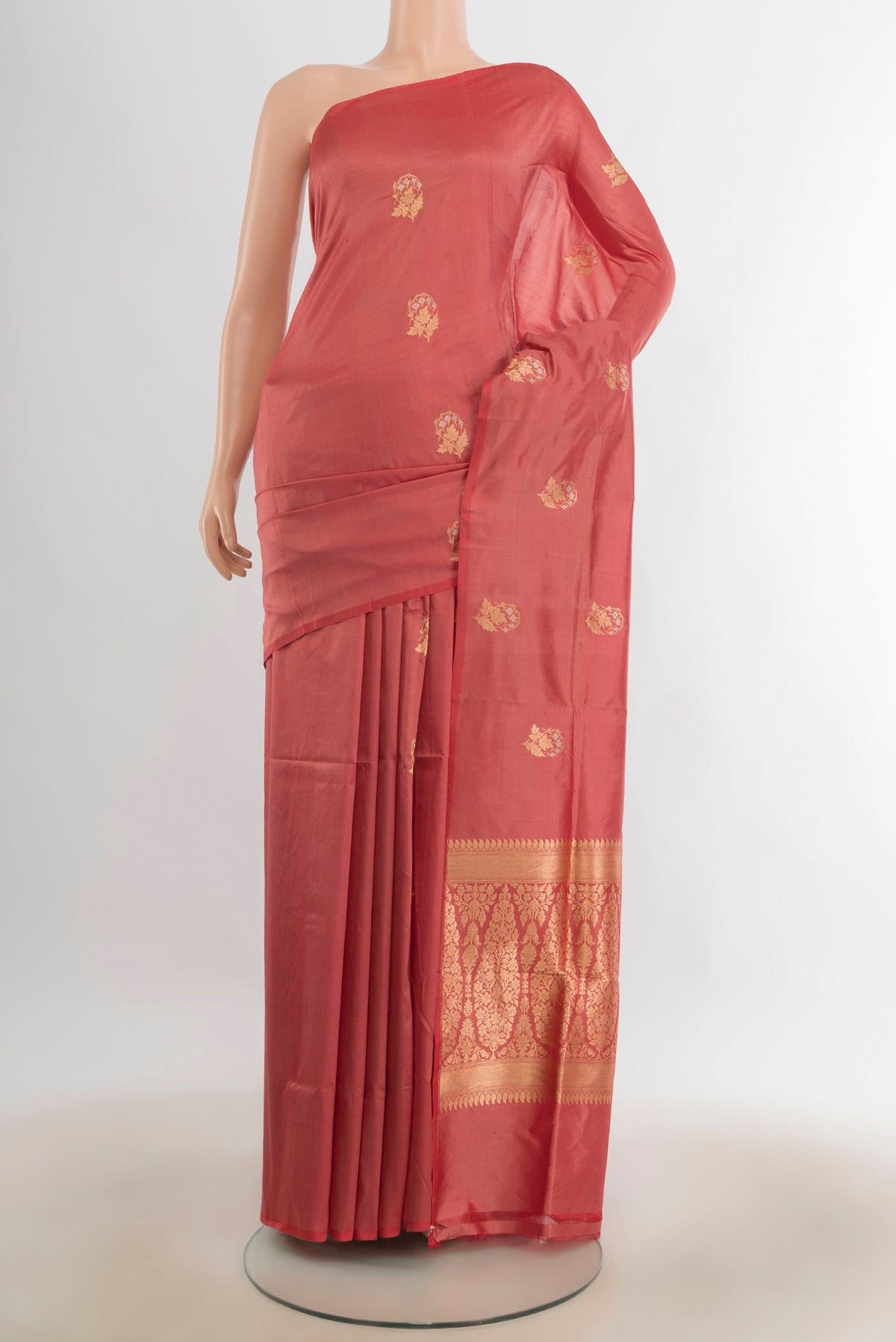 Pure Silk Peach Banarasi Katan Saree with Zari Butta on the body and Silk Border.  displayed on a mannequin