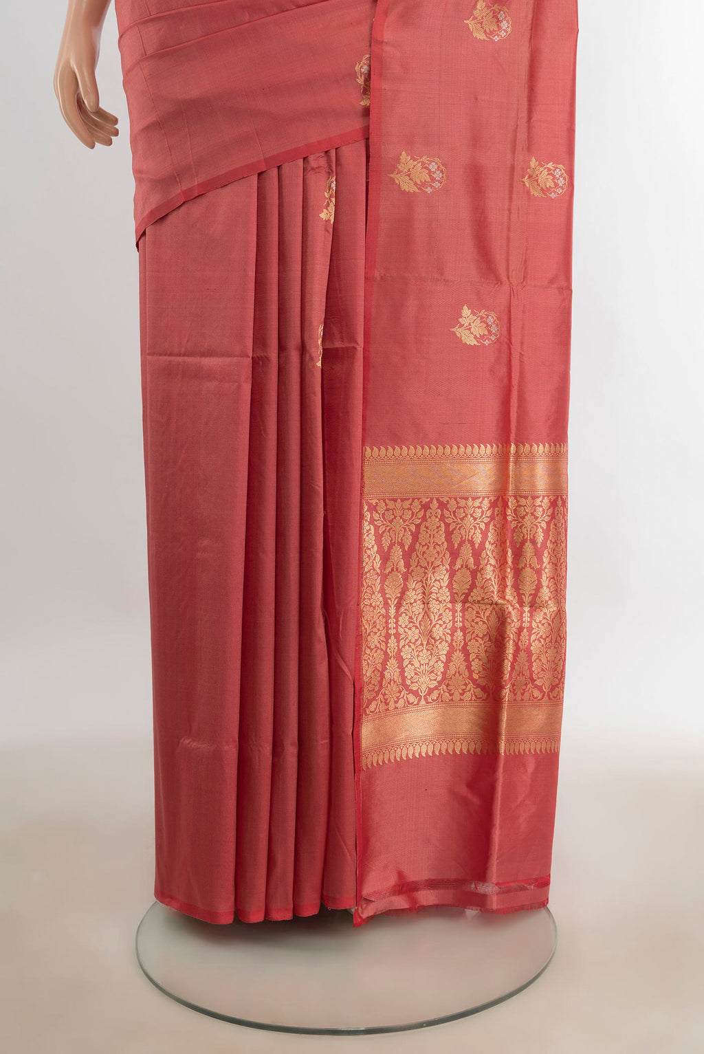 Pleats and pallu of Pure Silk Peach Banarasi Katan Saree with Zari Butta on the body and Silk Border. 