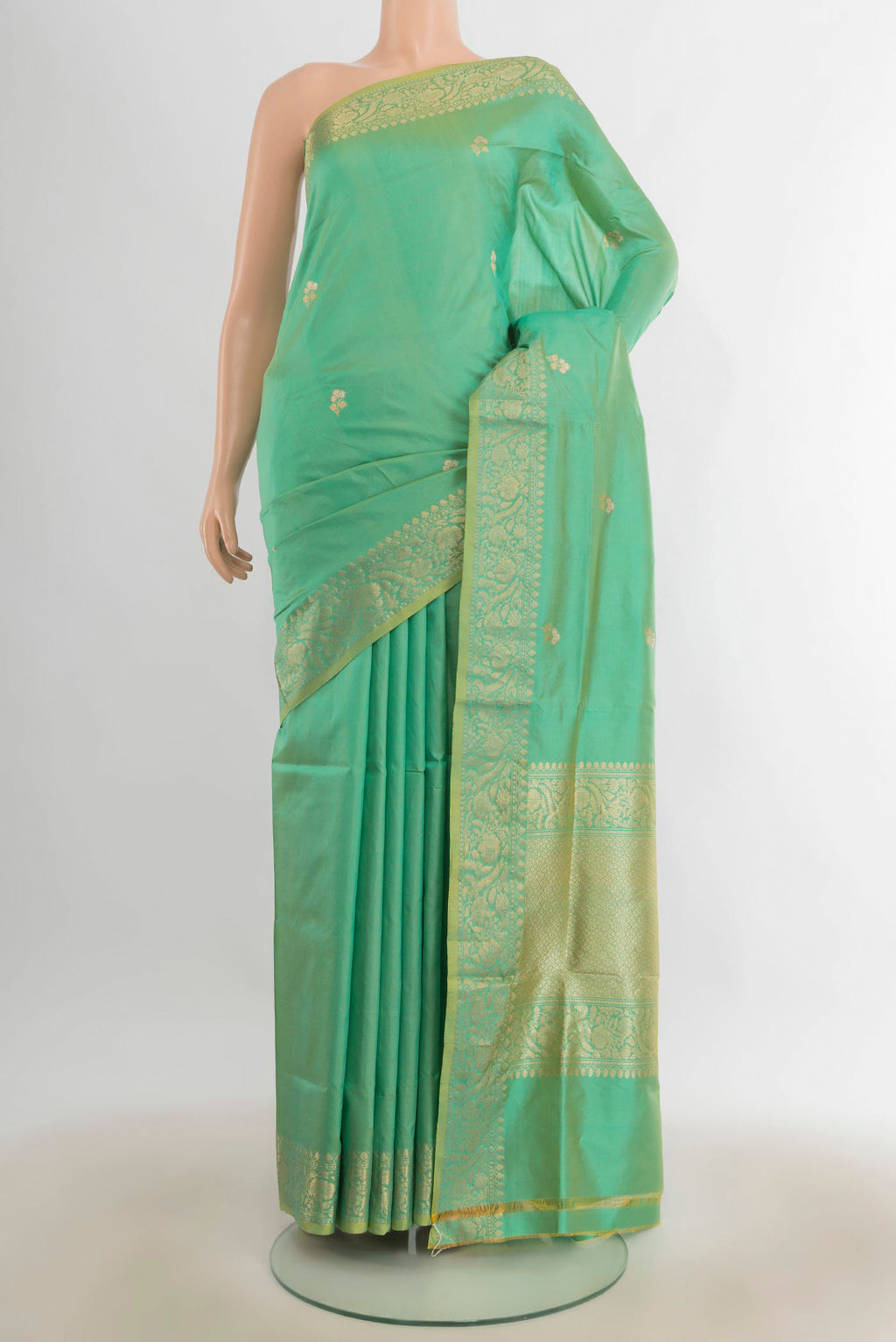 Pure Silk Pista Green Banarasi Katan Saree with Zari Butta on the body and Silk Border.  displayed on a mannequin