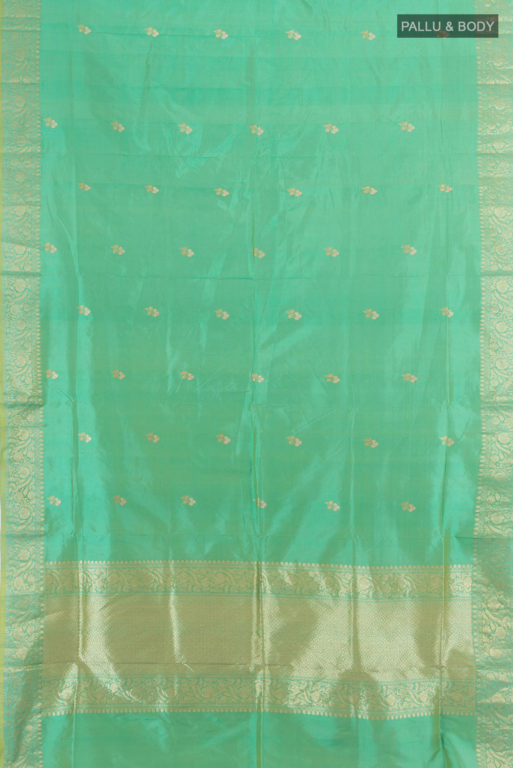 Flat view of Pure Silk Pista Green Banarasi Katan Saree with Zari Butta on the body and Silk Border. 