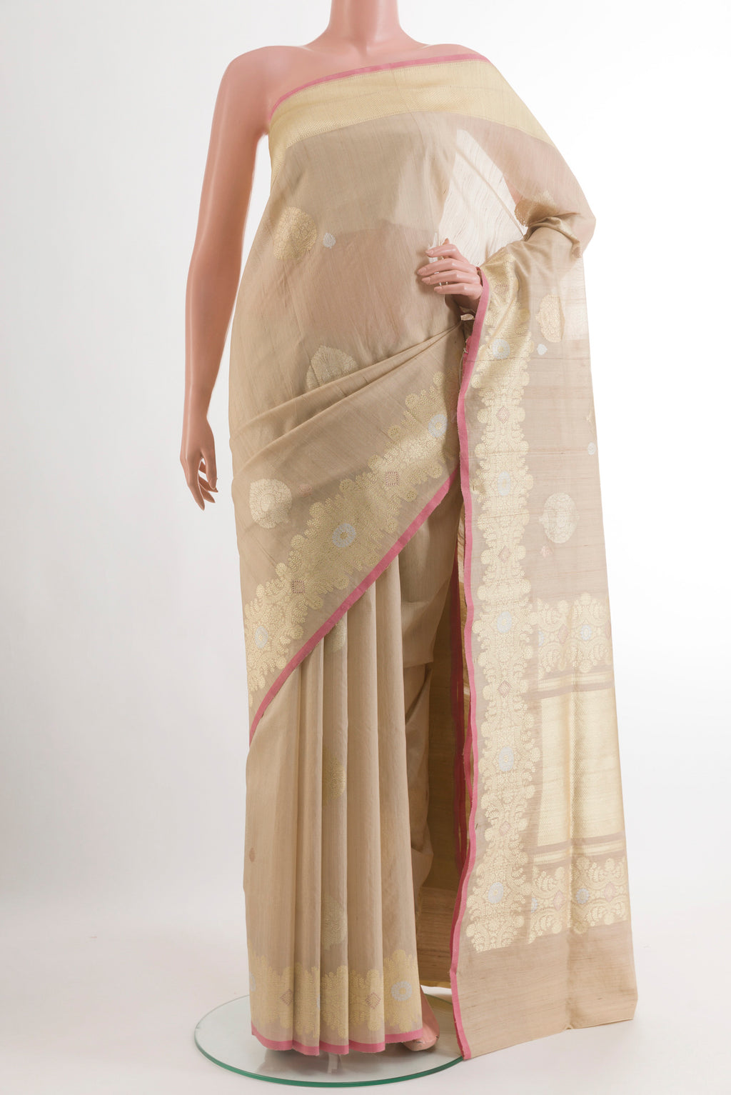 Beige Banarasi Tussar Silk Saree with Zari Butta on the body and Zari Border.  displayed on a mannequin