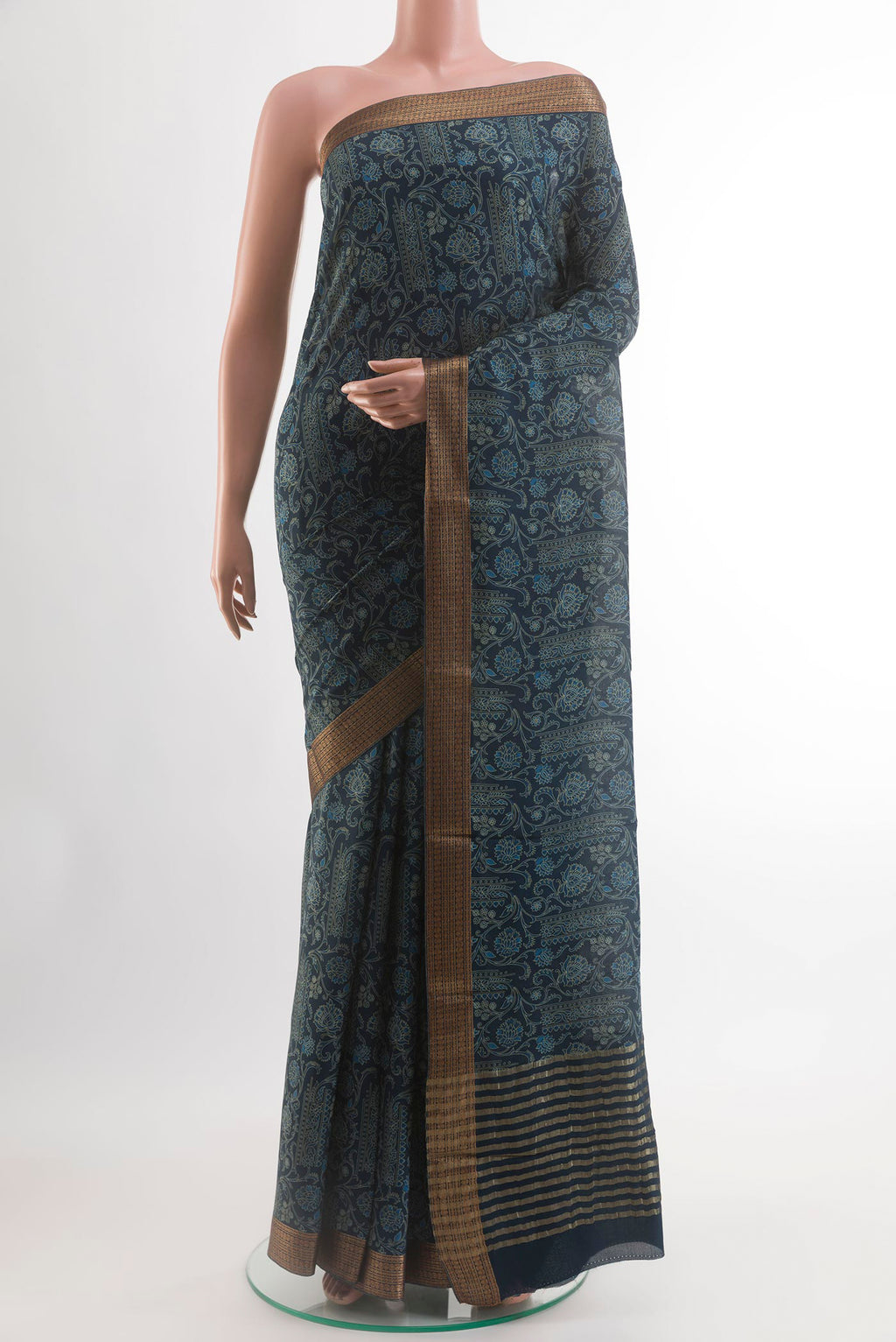 Blue Crepe Saree with Printed design on the body and Zari Border.  displayed on a mannequin