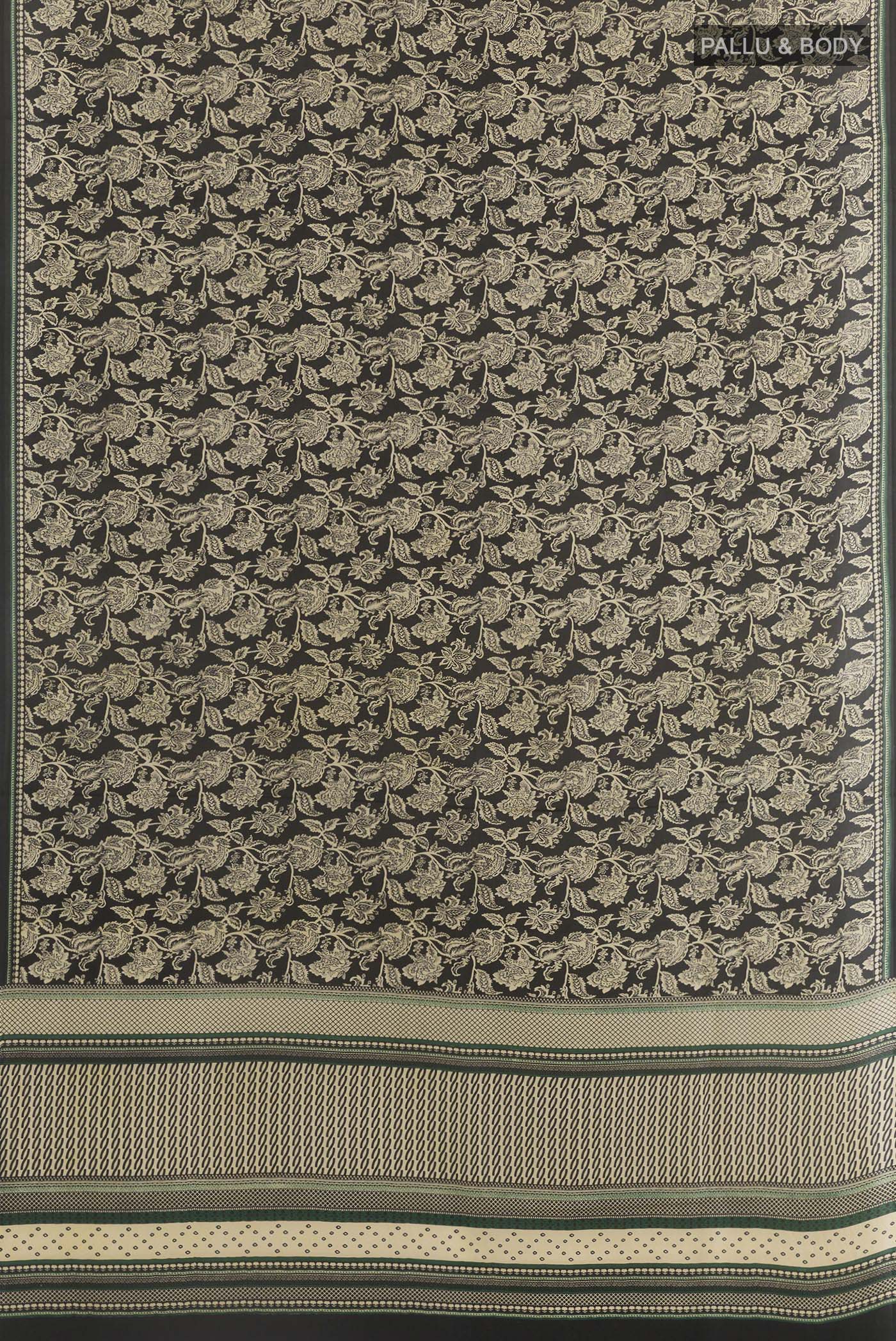 Flat view of Black Crepe Saree with Printed design on the body and Printed Border. 