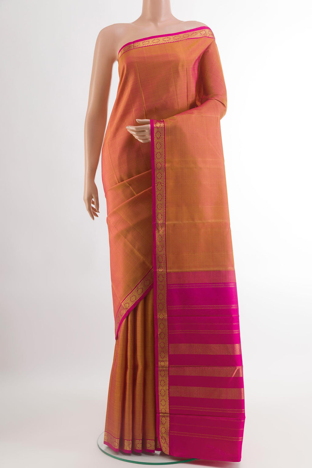 Mustard Kanjivaram Silk Saree with Plain Body and Zari Border.  displayed on a mannequin