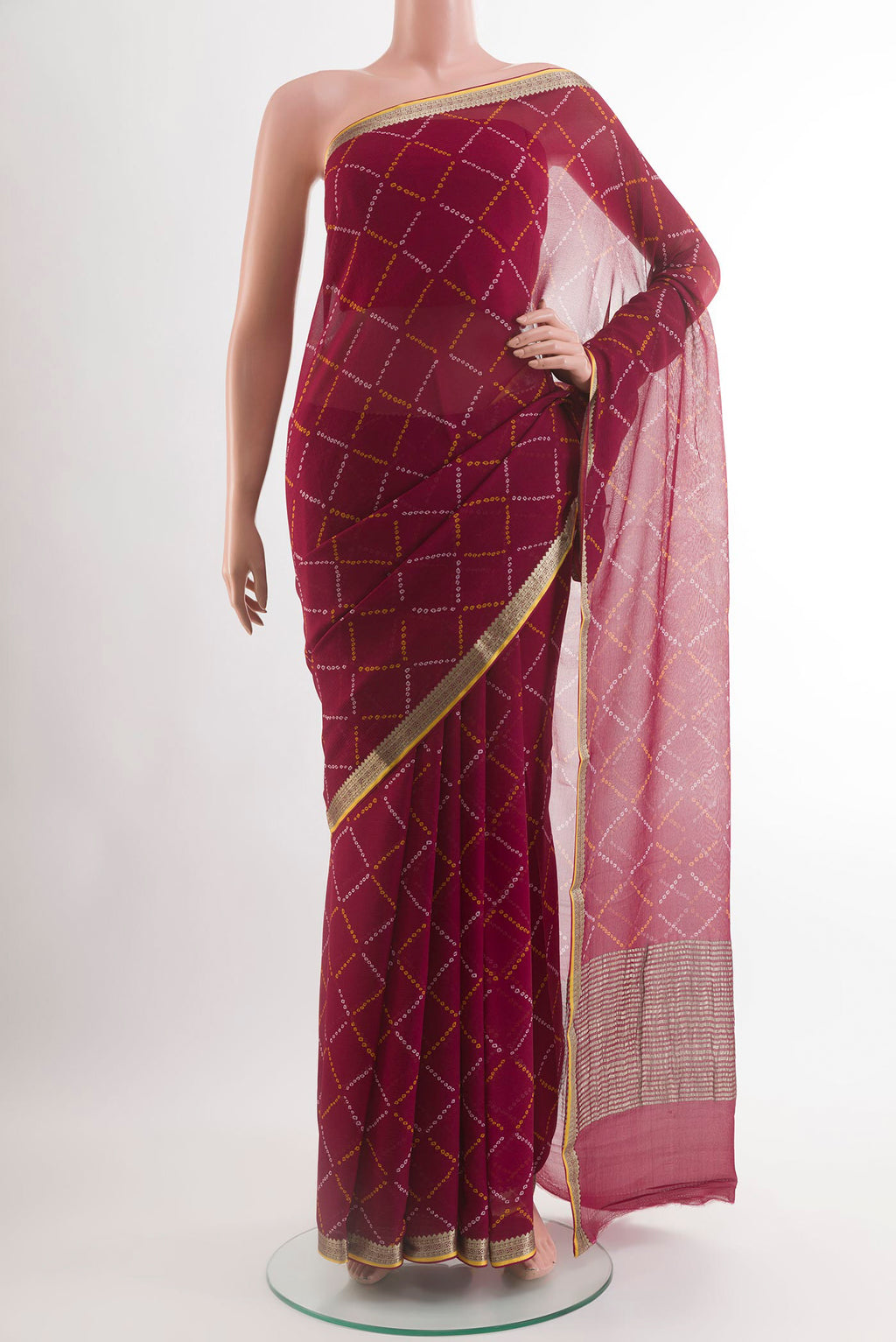 Maroon Chiffon Saree with Printed design on the body and Zari Border.  displayed on a mannequin