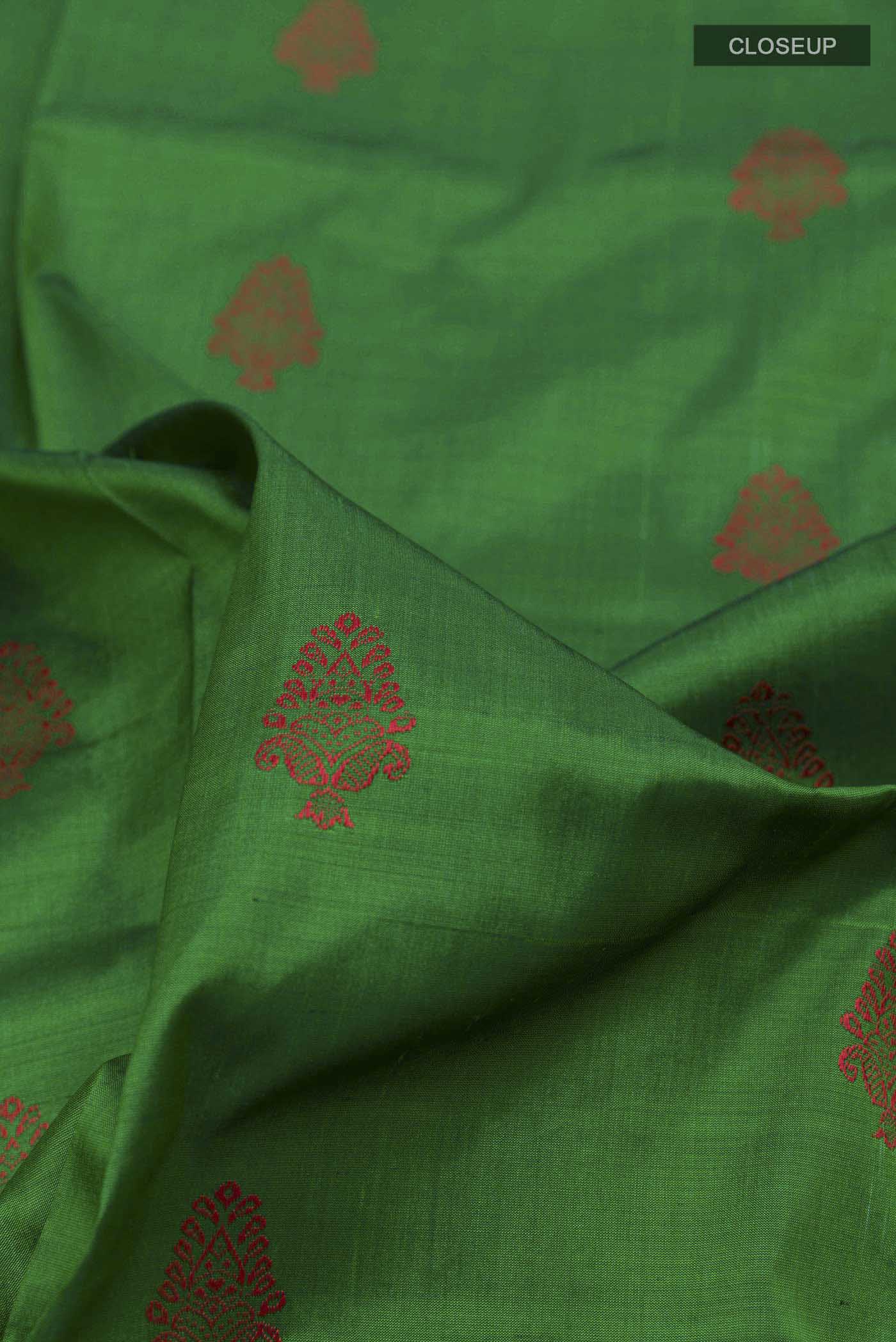 Close up of Green Orissa Silk Saree with Thread Butta on the body and Zari Border displaying folds
