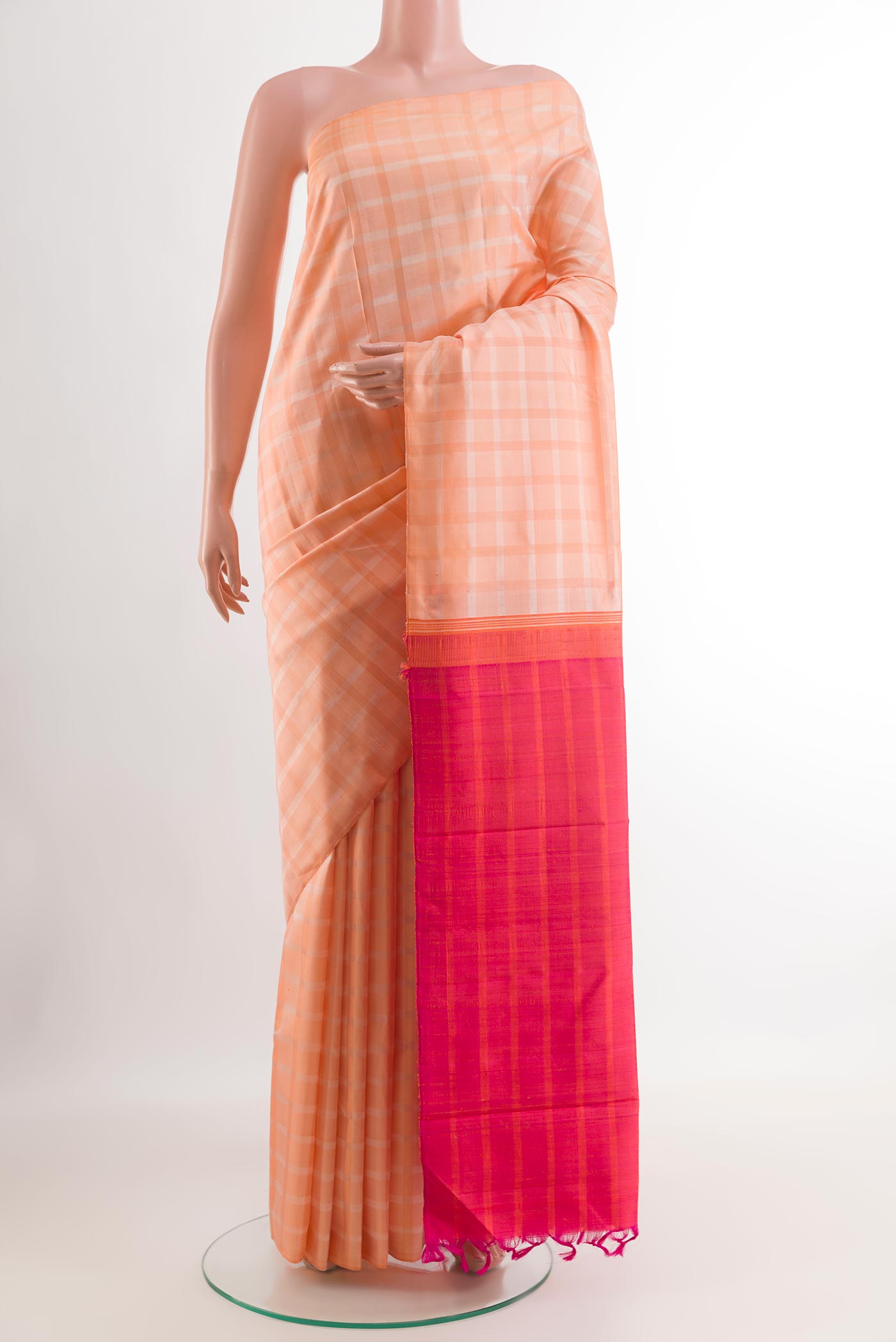 Rose pink Kanjivaram Silk Saree with Checked design on the body and Without Border.  displayed on a mannequin